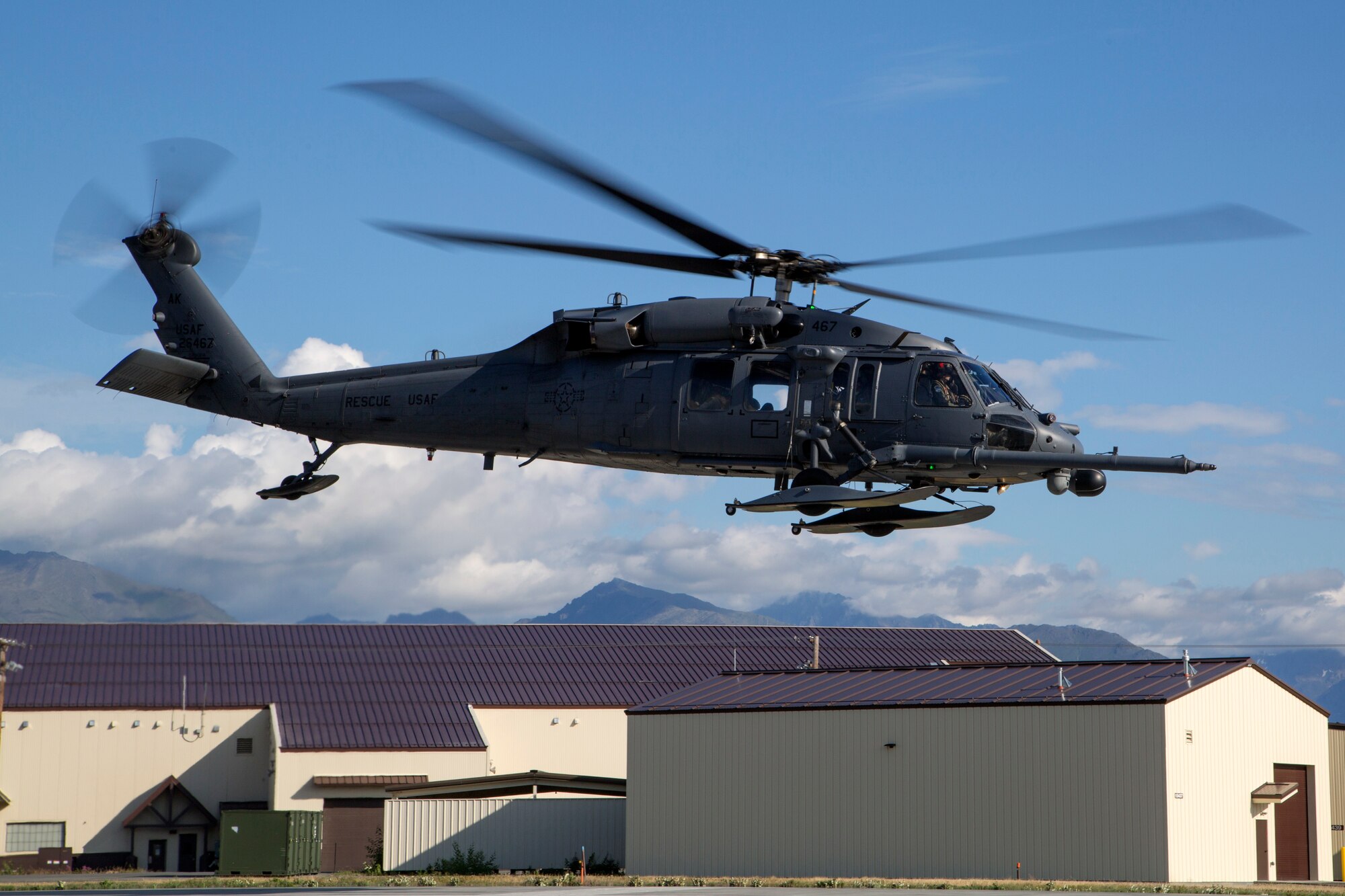 An Alaska Air National Guard HH-60G Pave Hawk helicopter, assigned to the 210th Rescue Squadron, takes off from Joint Base Elmendorf-Richardson, Alaska, July 23, 2015. The 210th Rescue Squadron provides emergency rescue services in addition to training for wartime combat search-and-rescue missions.