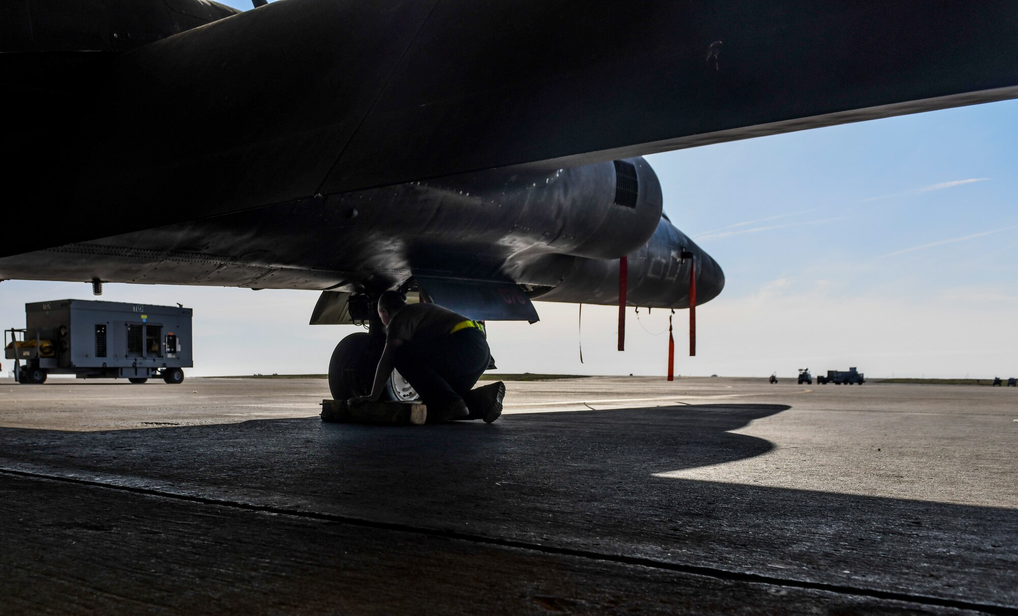 9th Aircraft Maintenance Squadron (AMXS) dedicated crew chief and members tow a U-2 Dragon Lady into a hangar