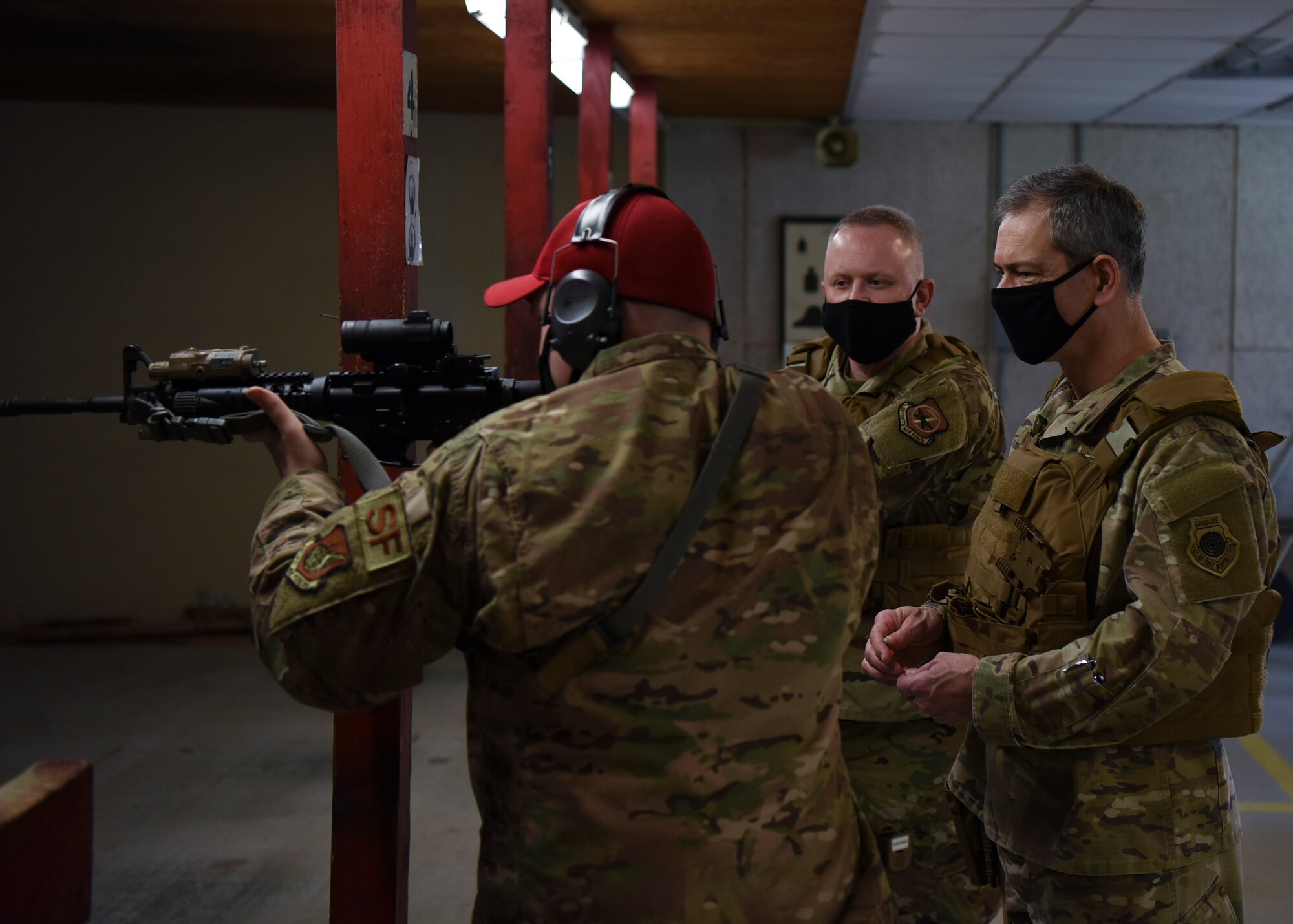 U.S. Air Force Lt. Gen. Ken Wilsbach, 7th Air Force commander, and Chief Master Sgt. Philip Hudson, 7th Air Force command chief, receive guidance on how to properly handle an M4 Carbine rifle from Staff Sgt. Austin Montgomery, 8th Security Forces Squadron armory NCO in charge, at Kunsan Air Base, Republic of Korea, May 1, 2020. Wilsbach and Hudson also fired the M18 SIG Sauer Modular Handgun System during their visit. (U.S. Air Force photo by Staff Sgt. Anthony Hetlage)