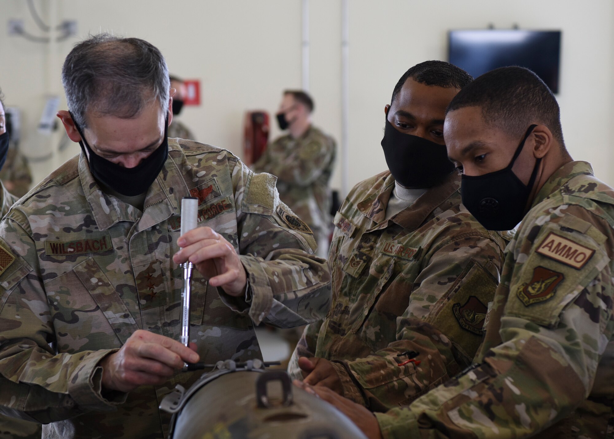 U.S. Air Force Lt. Gen. Ken Wilsbach, 7th Air Force commander, builds a guided-bomb unit with Airmen from the 8th Maintenance Squadron munitions flight during a visit at Kunsan Air Base, Republic of Korea, May 1, 2020. Wilsbach has been in command of the 7th Air Force since August 2018. (U.S. Air Force photo by Staff Sgt. Anthony Hetlage)