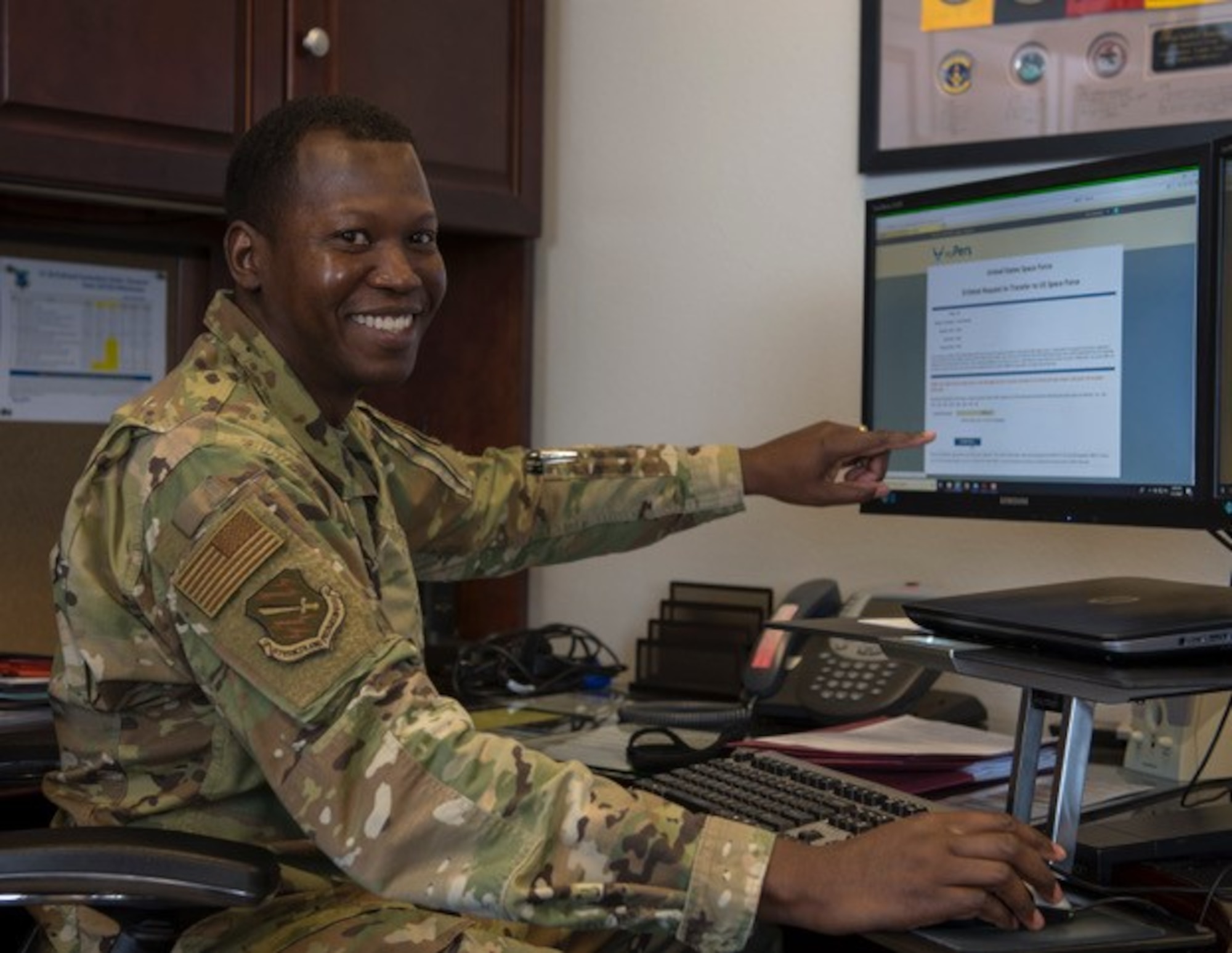 PETERSON AIR FORCE BASE, Colo. — Chief Master Sgt. Jacob Simmons, 21st Space Wing command chief, smiles as he submits his application to transfer to the United States Space Force May 1, 2020 on Peterson Air Force Base, Colorado. On May 1, 1992, he enlisted in the United States Air Force, making his 28th anniversary the day that he starts his path towards joining the new military branch, all while coincidentally being National Space Day.  To apply and transfer, Simmons had to fill out a DD From 368, as well as a USSF Enlisted Request to Transfer to the U.S. Space Force. (U.S. Air Force photo by Airman 1st Class Andrew Bertain)