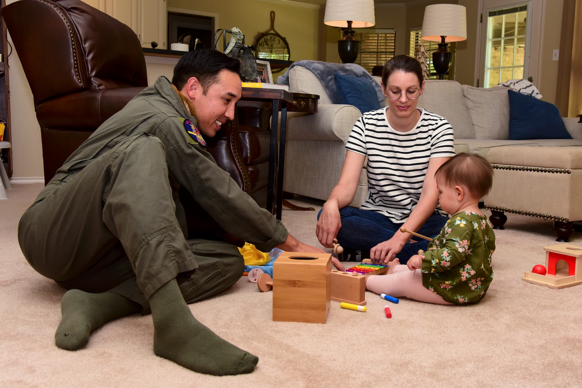 Capt. Joshua White, 434th Flying Training Squadron X flight commander and instructor pilot, Candice White, his wife and Dylan their daughter, spend some quality time together before work, April 23, 2020 in Del Rio, Texas. During quarantine, they enjoy going on walks, playing in the living room and video chatting with family who lives farther away. “Spending time with my family has always been important to me and is even more important now,” White said. “This pandemic has made me more thankful for the small things in life and appreciative of the present.” (U.S. Air Force photo by Senior Airman Anne McCready)