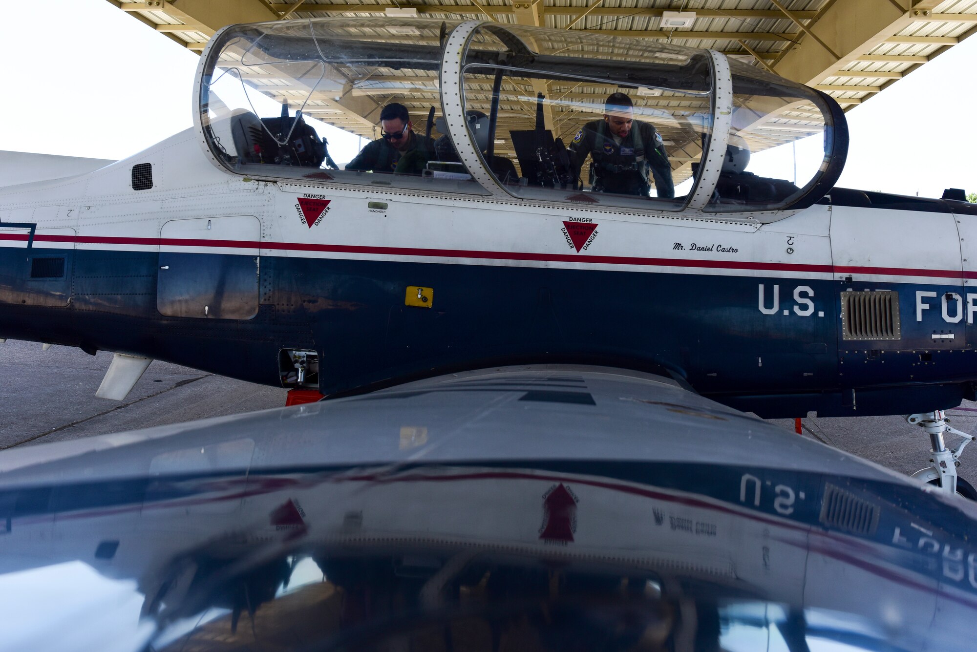 Capt. Joshua White, 434th Flying Training Squadron X flight commander and instructor pilot, and 2nd Lt. Roderick Byars, 47 Student Squadron student pilot, prepare a T-6A Texan II for flight, April 23, 2020 at Laughlin Air Force Base, Texas. The biggest impact White is seeing the Coronavirus take on students and instructors is the ever-changing schedule, which White says they are overcoming by staying flexible. (U.S. Air Force photo by Senior Airman Anne McCready)