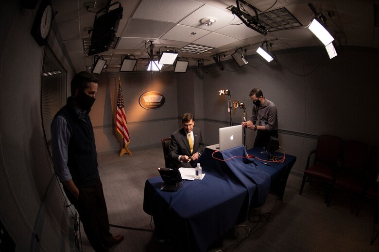 Masked men prepare for a virtual conversation.