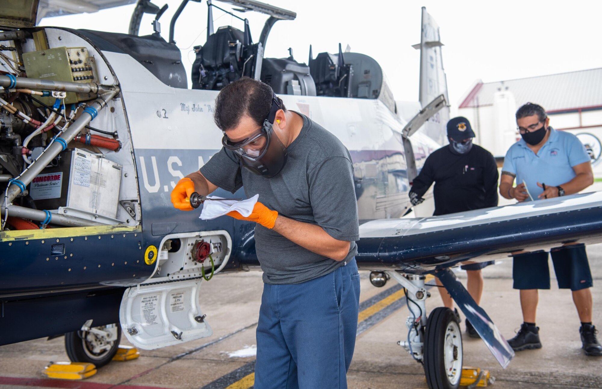 Greg Garcia, 12th Aircraft Maintenance Squadron, checks the oil of a T-6 Texan aircraft at Joint Base San Antonio-Randolph April 7.