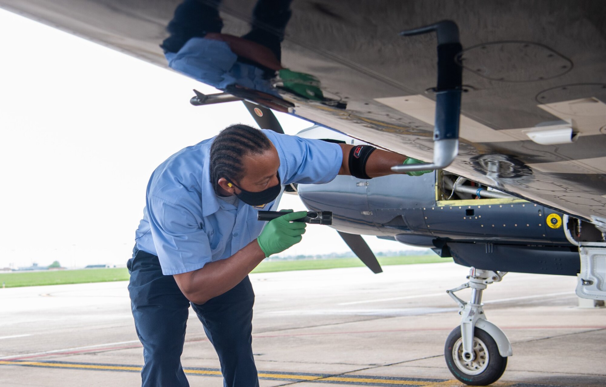 Gaylon Davis, 12th Aircraft Maintenance Squadron, provides routine maintenance by inspecting the wing of a T-6 Texan aircraft at Joint Base San Antonio-Randolph April 7.