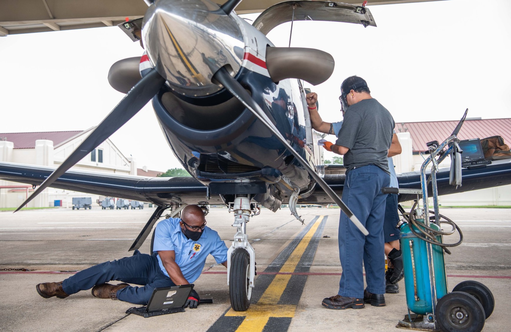 Shevon Vacianna, 12th Aircraft Maintenance Squadron, conducts routine maintenance by inspecting the front tire of a T-6 Texan aircraft at Joint Base San Antonio-Randolph April 7.
