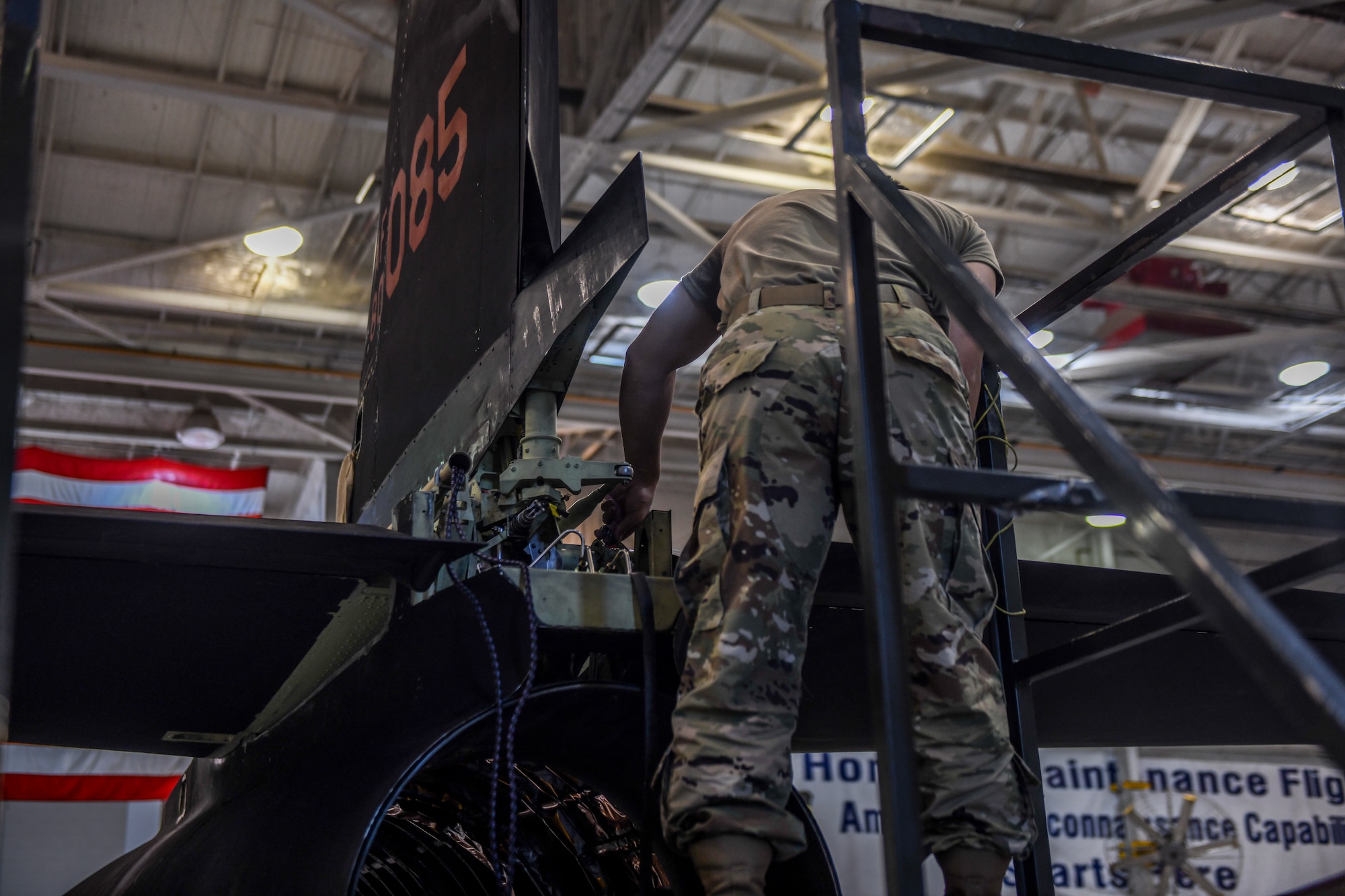 9th Maintenance Squadron repair and reclamation craftsman, work mon the tail of a U-2 Dragon Lady