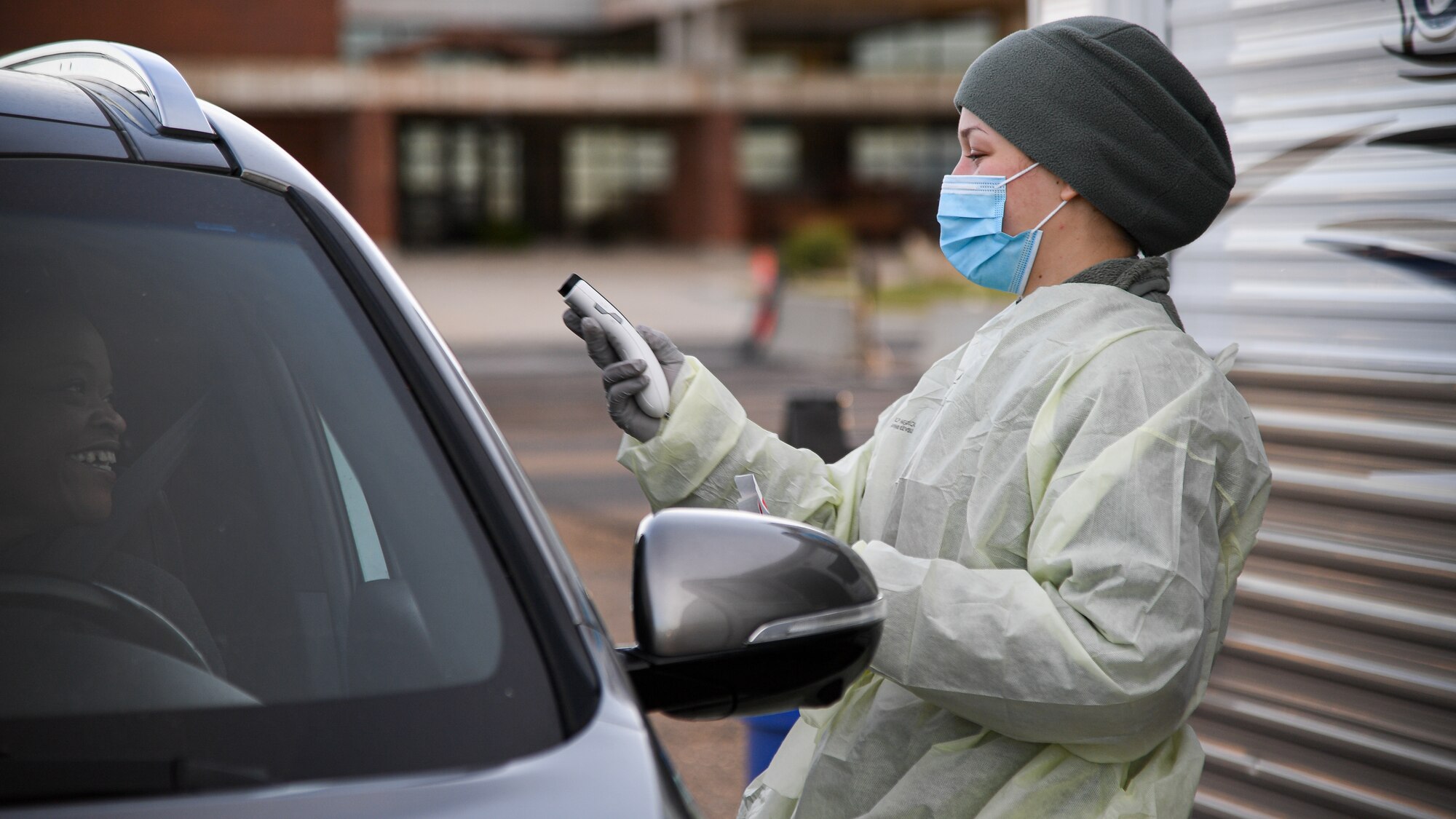Airman Tori Salem, 75th Medical Group, holds a thermometer during a drive-thru COVID-19 screening.