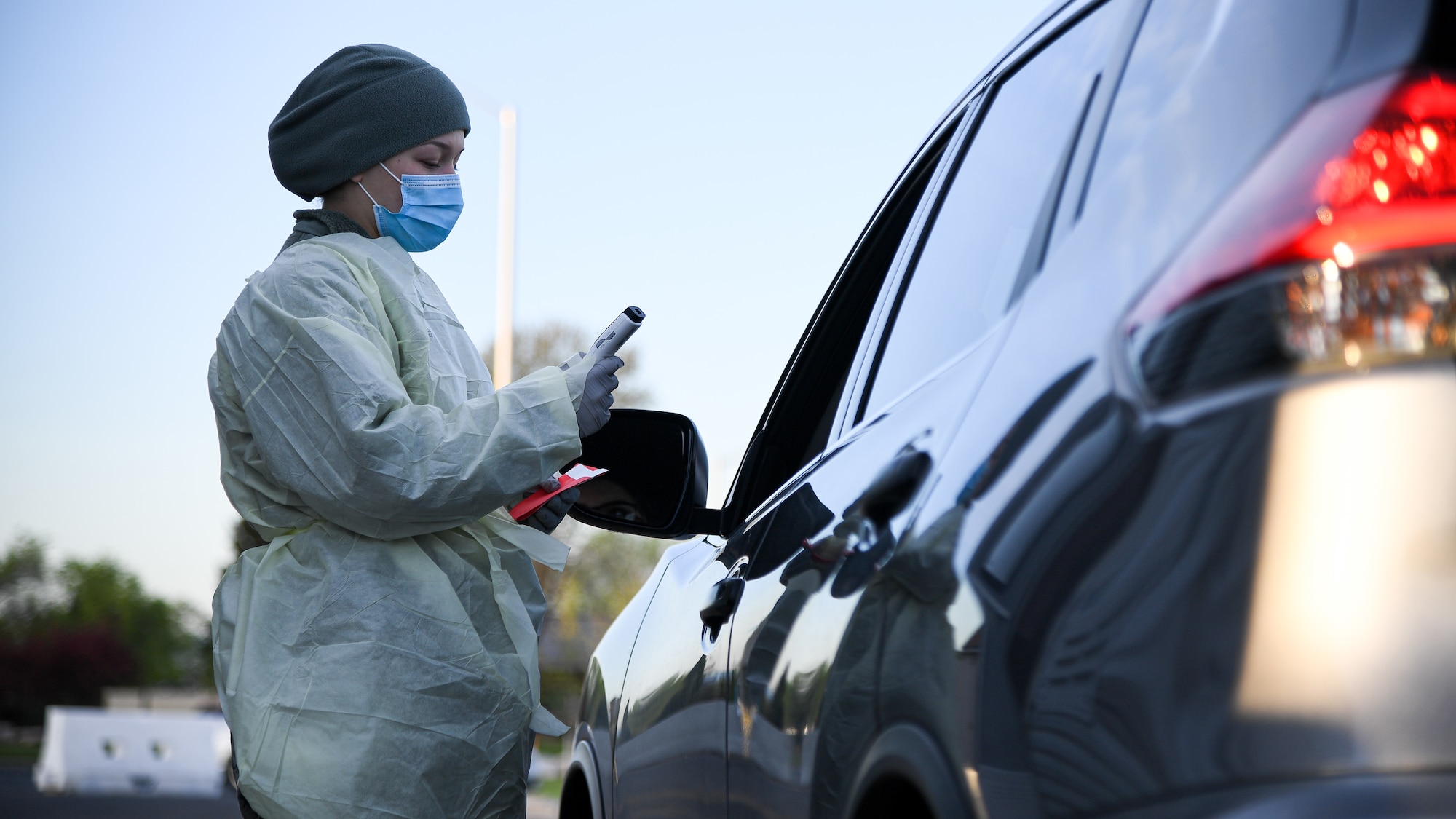 Airman Tori Salem, 75th Medical Group, conducts a drive-thru COVID-19 screening.