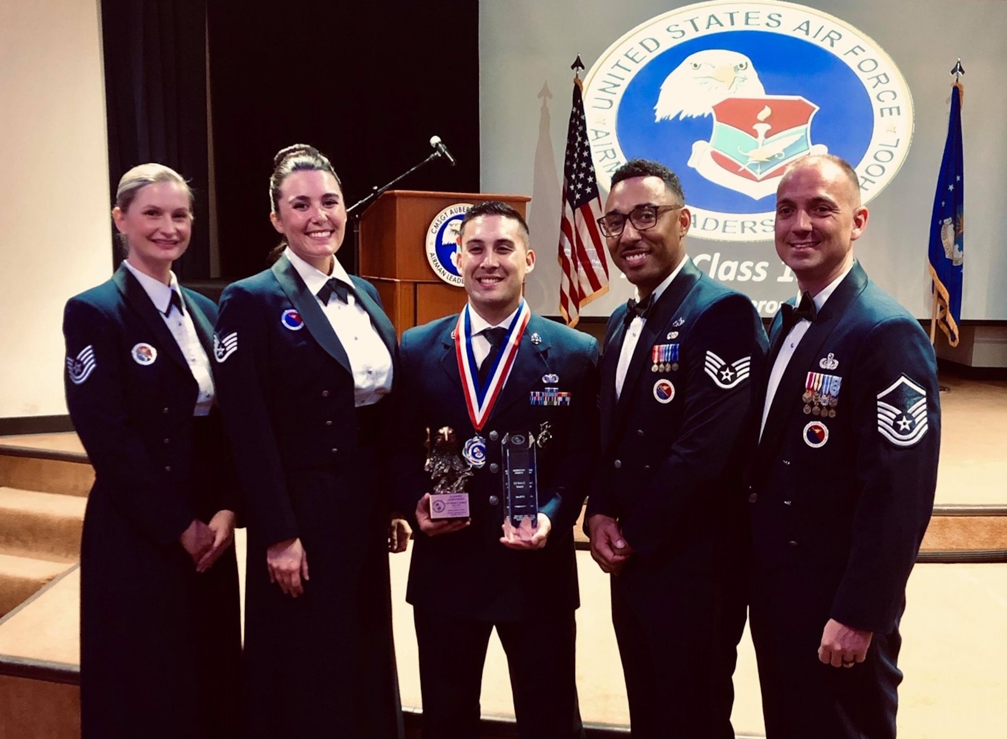 U.S. Air Force Tech. Sgt. Shawna Wise, Staff Sgt. Marissa Nelson, Staff Sgt. Sanchez Banks and Master Sgt. Matthew Orlando, the 6th Force Support Squadron Airman Leadership School (ALS) instructor team, pause for a photo with Staff Sgt. Travis Somera, a 6th Security Forces Squadron entry controller during an ALS graduation ceremony, Oct. 17, 2019 at MacDill Air Force Base, Fla.