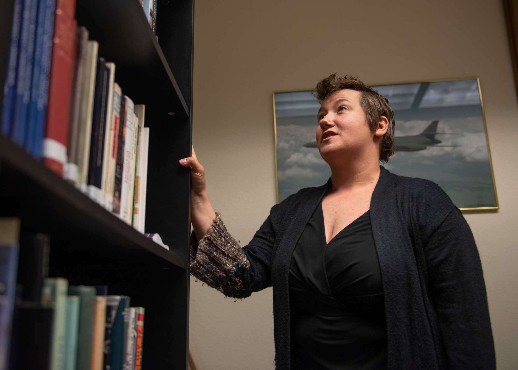 Chrissie Parker, 366th Fighter Wing historian, shows her collection of resources, May 4, 2020, at Mountain Home Air Force Base, Idaho. Parker reached out for help with transcribing oral interviews when the 366th Operation Support Squadron offered to help. (U.S. Air Force photo by Airman Natalie Rubenak)