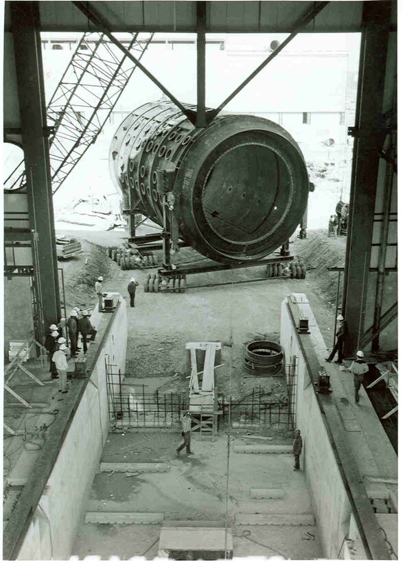 The first of two 550,000-pound test cell structures is pushed into the under construction Aeropropulsion Systems Test Facility building at Arnold Air Force Base in May 1980. The test cell was transported to the site on a 100,000-pound, 72-wheel transport frame specially constructed for the purpose. (U.S. Air Force photo)