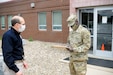 Staff Sgt. Raymond Mutiso, a combat medic with the 108th Area Medical Support Company, 213th Regional Support Group screens a contractor outside the 28th ECAB Armory. The 28th ECAB is scheduled to deploy soon and must gather for training. Soldiers like Mutiso and Marianos screen 28th ECAB Soldiers everyday before they enter the building or start their training for the day to prevent the spread of COVID-19 in the formation.