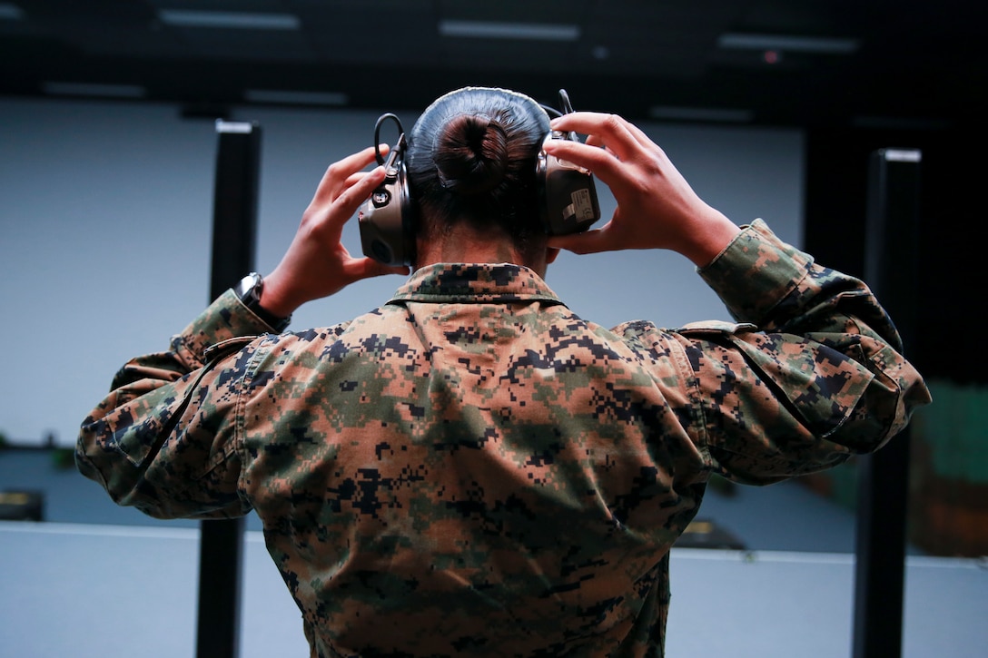 A U.S. Marine puts on ear protection before shooting on the Weapon Training Simulation System at Robertson Barracks in Darwin, Northern Territory, Australia, April 29.