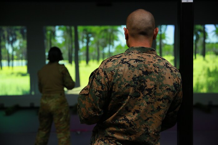 A U.S. Marine coaches U.S. Marines and Australian Defence Force service members through shooting the M4 carbine at Robertson Barracks in Darwin, Northern Territory, Australia, April 29.