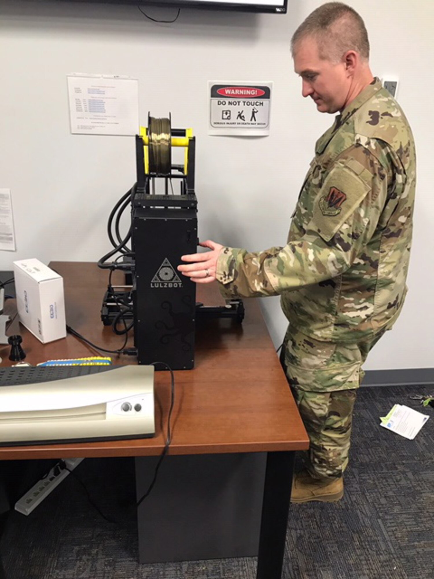 Tech. Sgt. Ryan Hawk, 552nd Maintenance Group, works with a 3D printer in the Continuous Improvement Office. Utilizing a 3D printer, the office prototyped approximately 40 face masks and face shields to support the 72nd Security Forces during the COVID-19 pandemic.