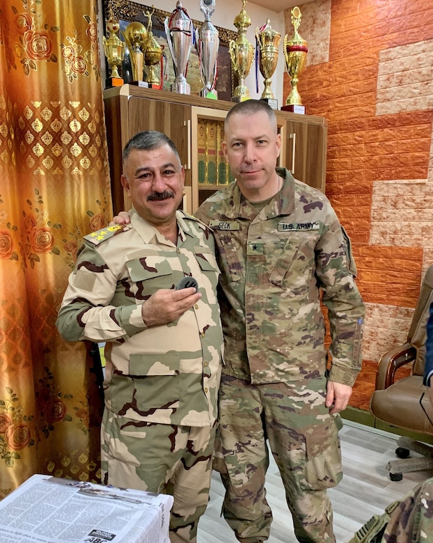 U.S. Army Brig. Gen. Howard Geck, commanding general, 103rd Expeditionary Sustainment Command, presented the 103rd unit patch to Iraqi Army Brig. Gen. Mae'n, commander of the Iraqi Army Western Track Repair Facility, at Camp Taji, Iraq, Feb. 24, 2020.  (U.S. Army National Guard photo by Capt. Richard Wharton)