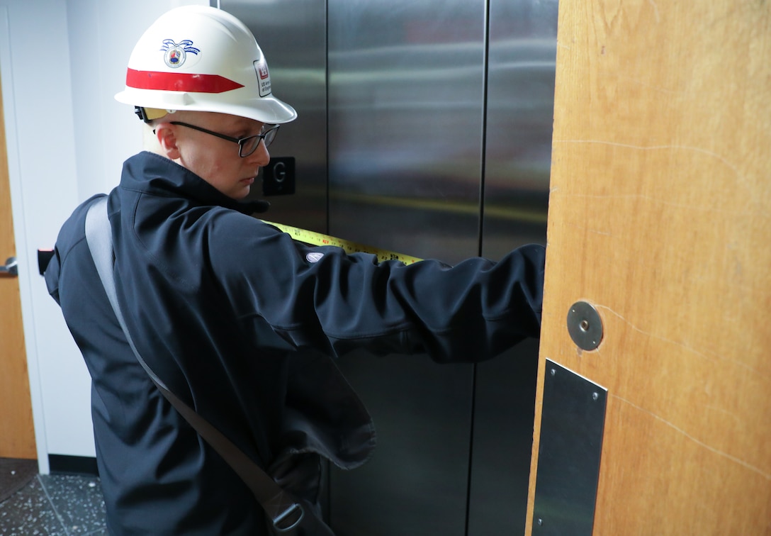 Andy Temeyer, architect, U.S. Army Corps of Engineers – Omaha District, measures the width of doors on an elevator April 6, during a site assessment of a building in Omaha, Neb., the state is considering turning into an alternate care facility in the battle against the COVID-19 pandemic. When requested by states and/or territories and funded by FEMA, USACE is conducting site assessments for potential alternate care facilities. A site assessment does not guarantee construction at that site.