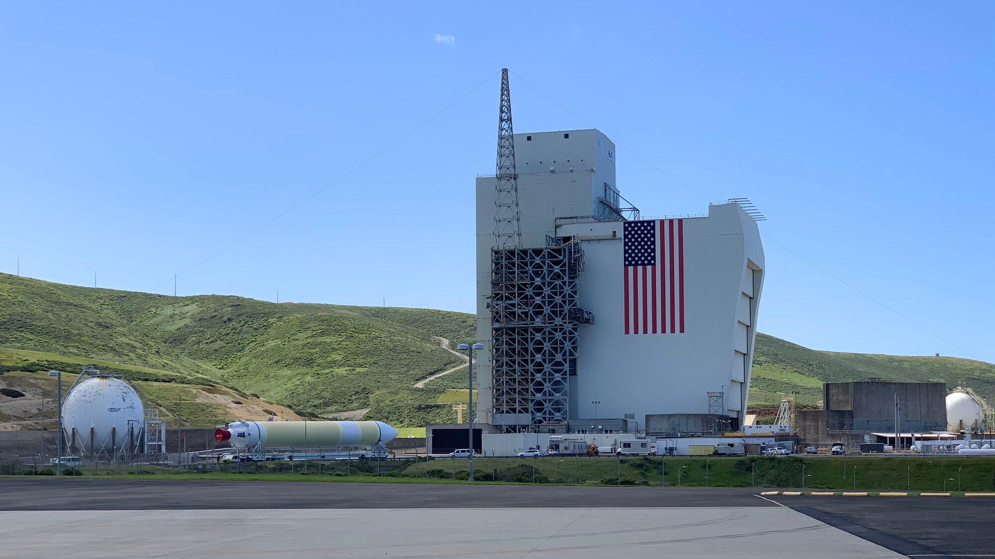 A Delta IV Heavy booster from a United Launch Alliance barge, known as the RocketShip, proceeds to the Horizontal Integration Facility May 4, 2020, at Vandenberg Air Force Base, Calif. A HIF is a building within which the stages of a multistage rocket are brought together before the assembled stack is rolled out to the launch pad or space launch complex and raised into a vertical position for final integration and launch. (Courtesy photo)