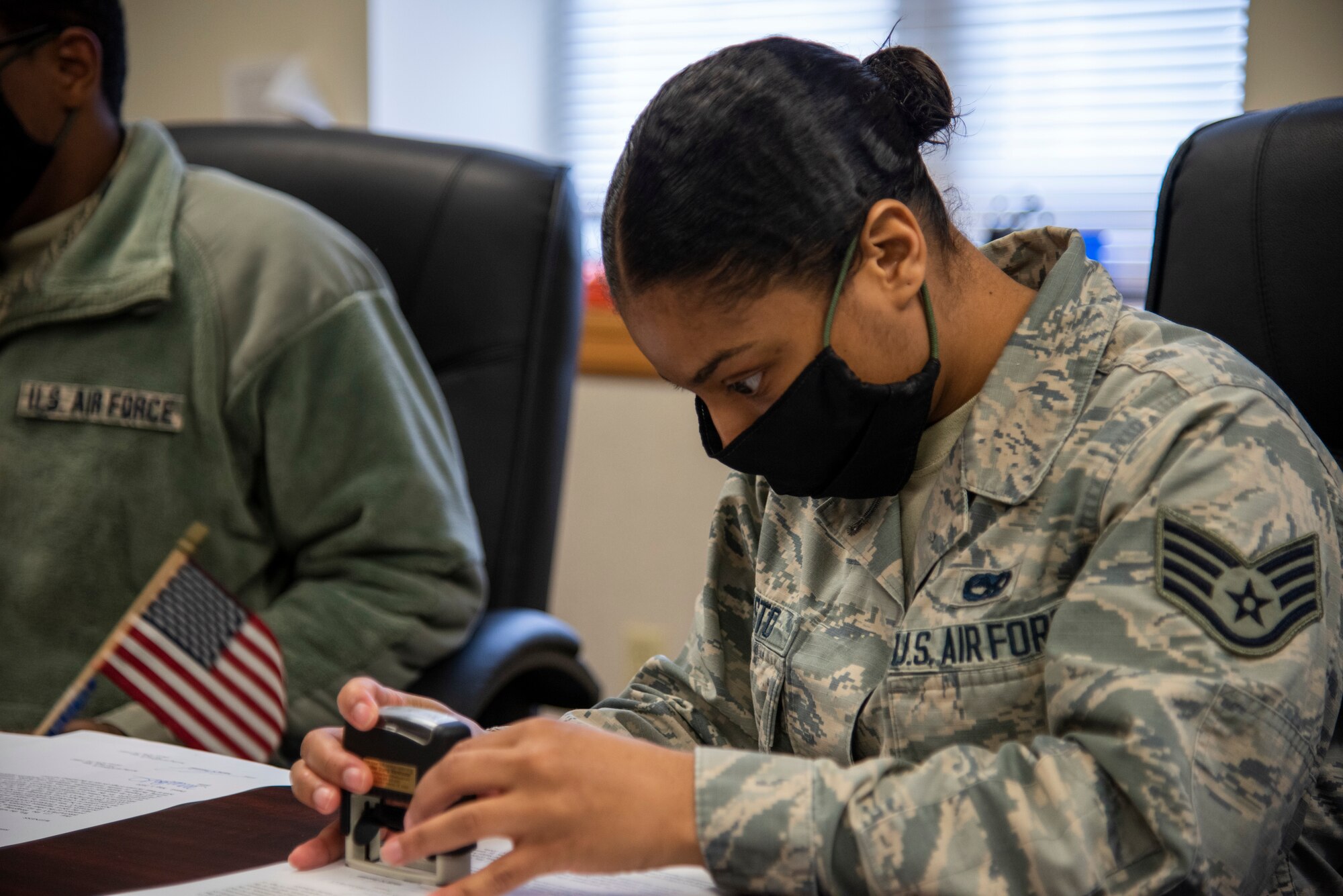 Staff Sgt. Tanea Resto, 436th Airlift Wing Legal Office NCOIC of military justice, stamps a document during an appointment May 1, 2020, at Dover Air Force Base, Delaware. Many legal office functions have shifted to teleworking; however, some appointments require in-person signatures. (U.S. Air Force photo by Airman 1st Class Jonathan Harding)