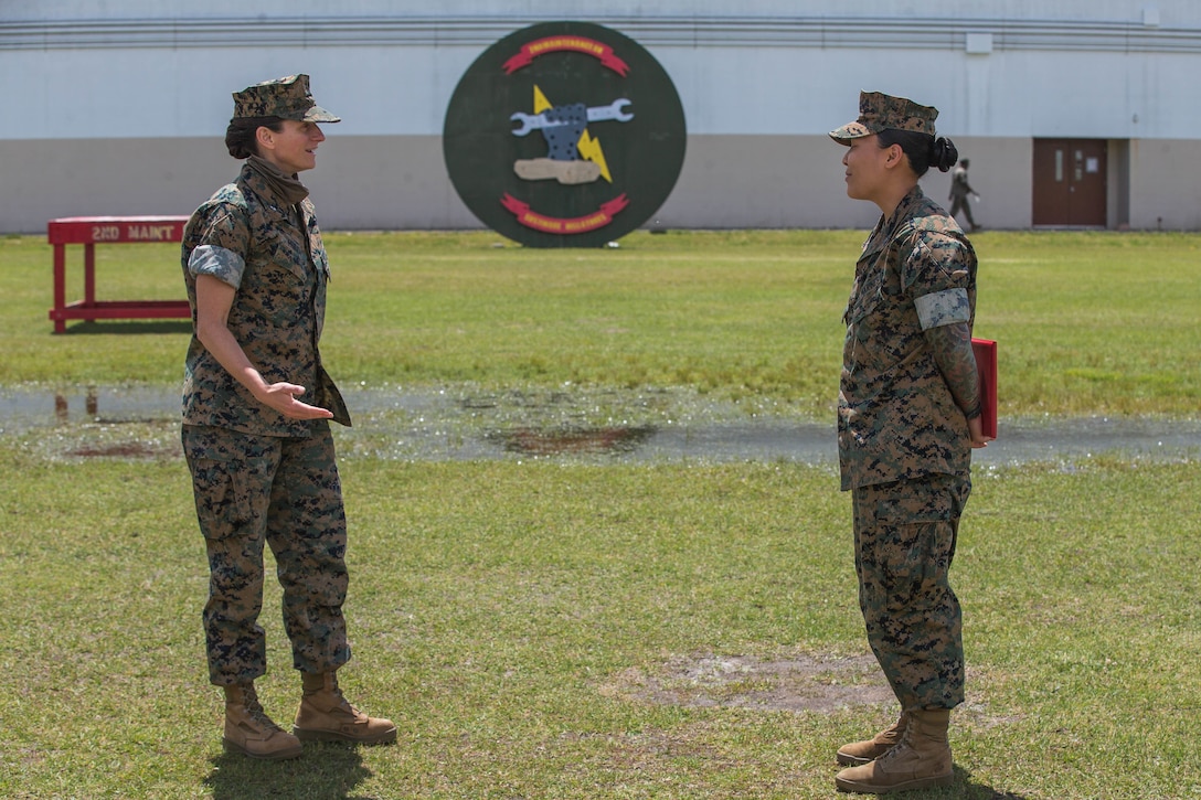U.S. Marine Corps Lt. Col. Kate Murray, left, battalion commander of 2nd Maintenance Battalion, speaks with Sgt. Jennifer Wilbur at Camp Lejeune, N.C., May 1, 2020. Wilbur, a 25 year-old Clearwater, Florida native and chief instructor for the College of Military Education Courses, 2nd Maintenance Battalion, was the winner of the second quarter’s Commanding General Innovation Challenge for her introduction of Design Thinking into command sponsored primary military education courses. Design Thinking encourages organizations to focus on the people they are creating for, which leads to better products, services, and internal processes. (U.S. Marine Corps photo by Lance Cpl. Scott Jenkins)