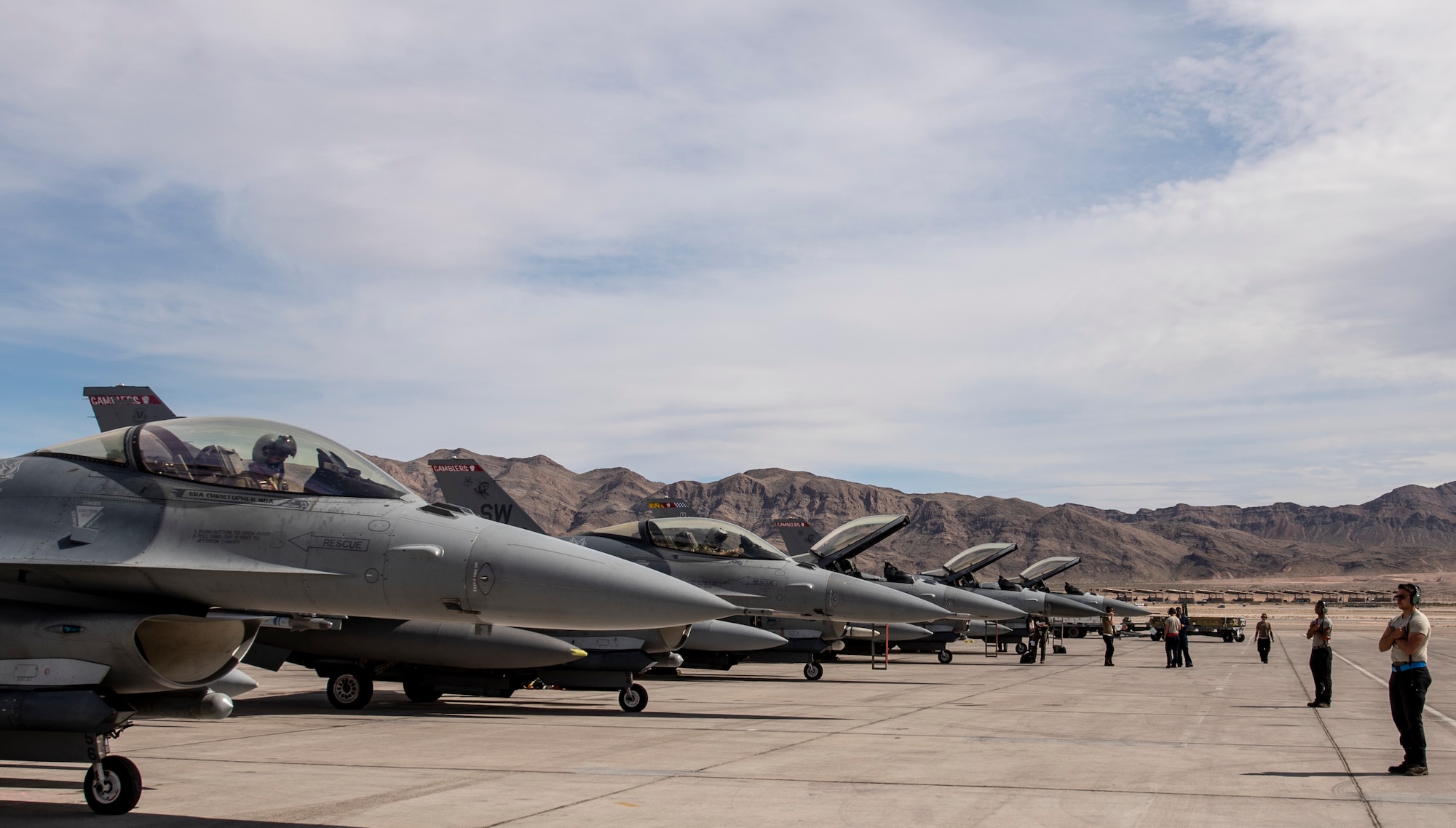 A picture of F-16's and Airmen on the flight line.