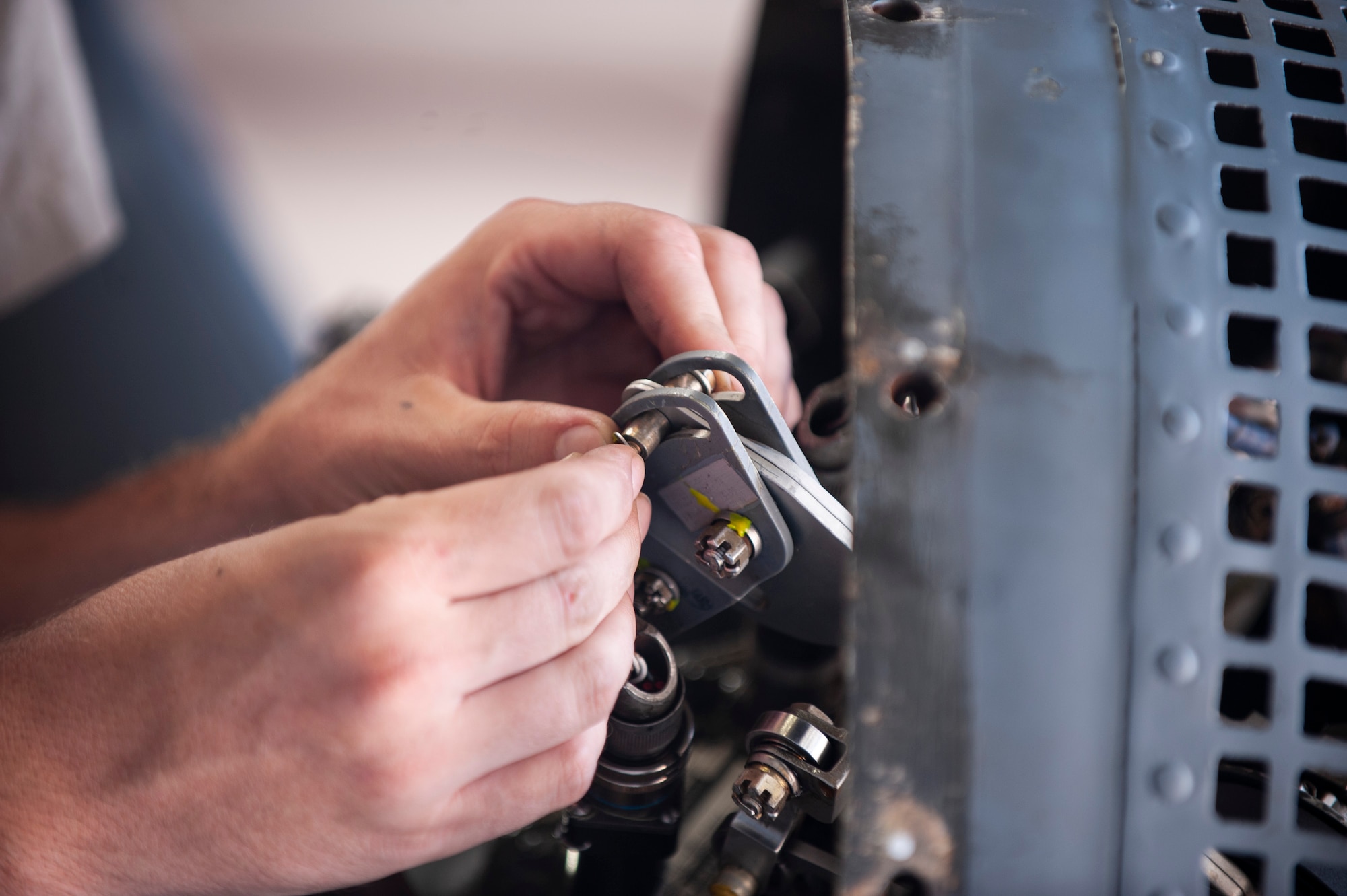 A photo of an Airman installing aircraft parts.