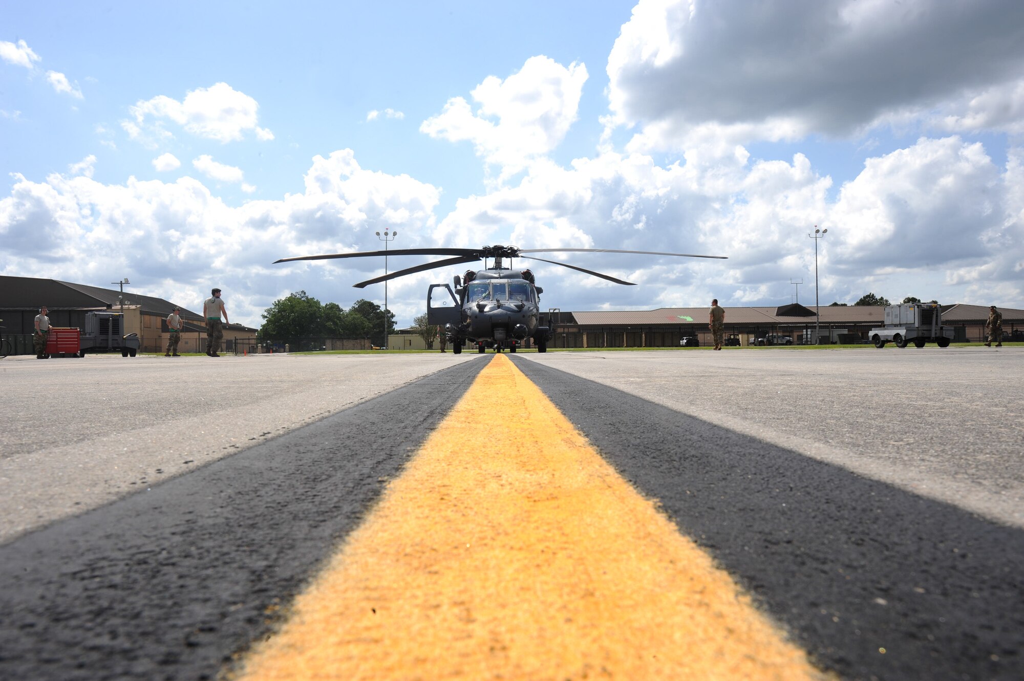 A photo of Airmen moving a helicopter.
