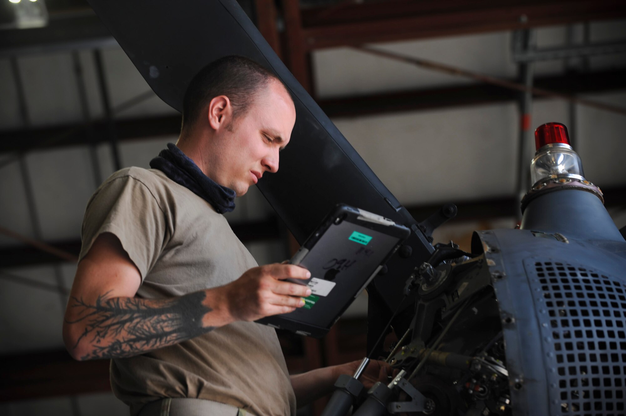 A photo of an Airman looking at a iPad.