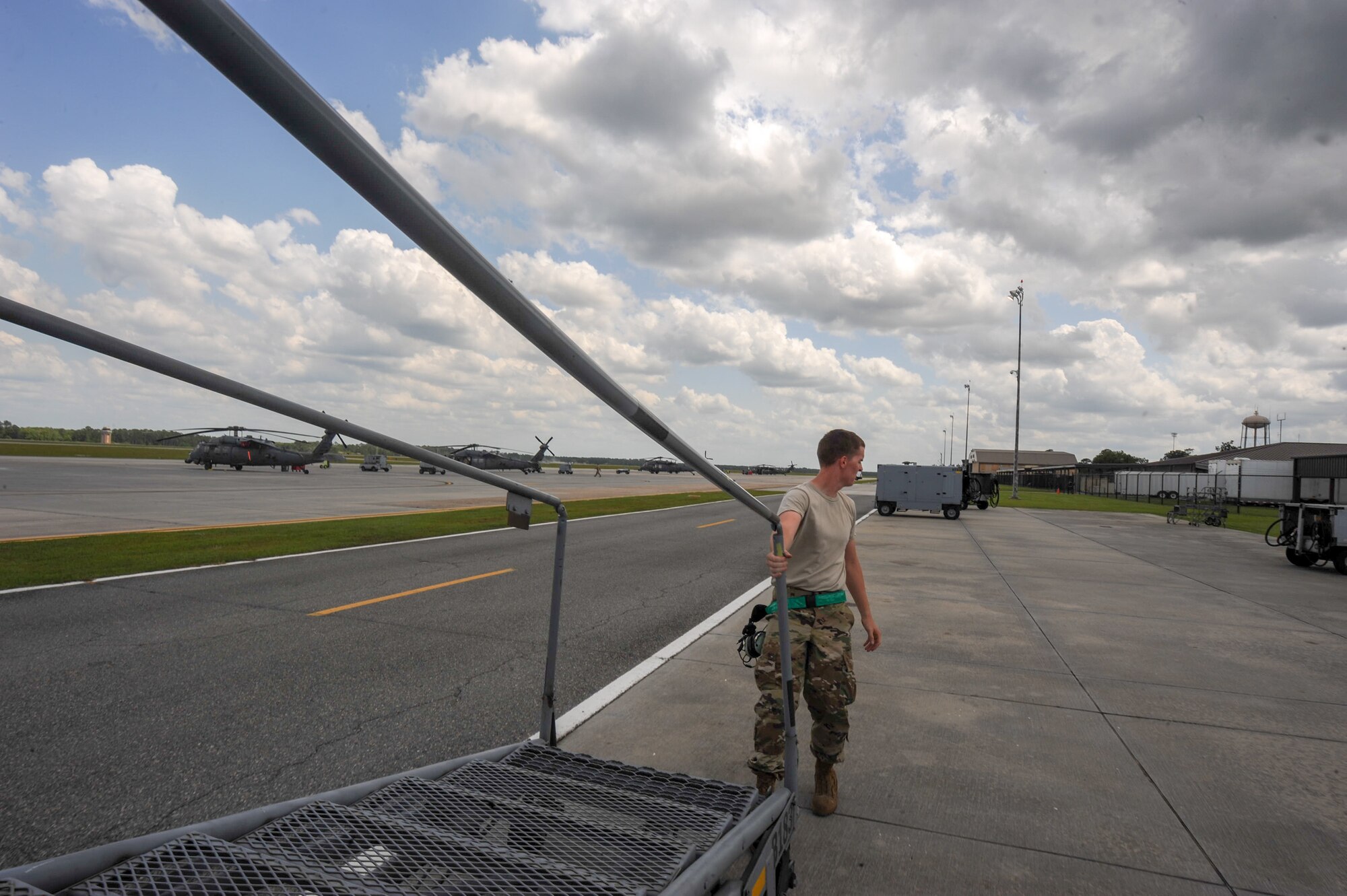 A photo of an Airman moving a stand.