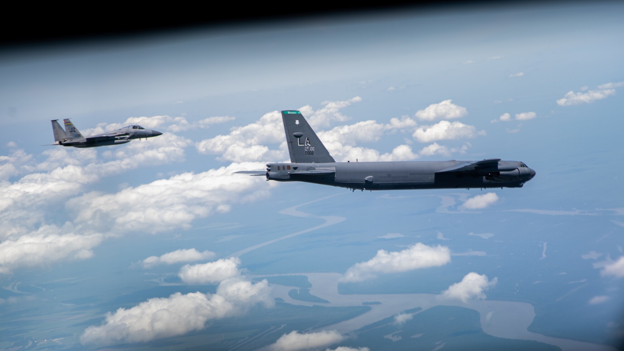 A B-52H Stratofortress and an F-15 Strike Eagle fly over South Louisiana, May 1, 2020.