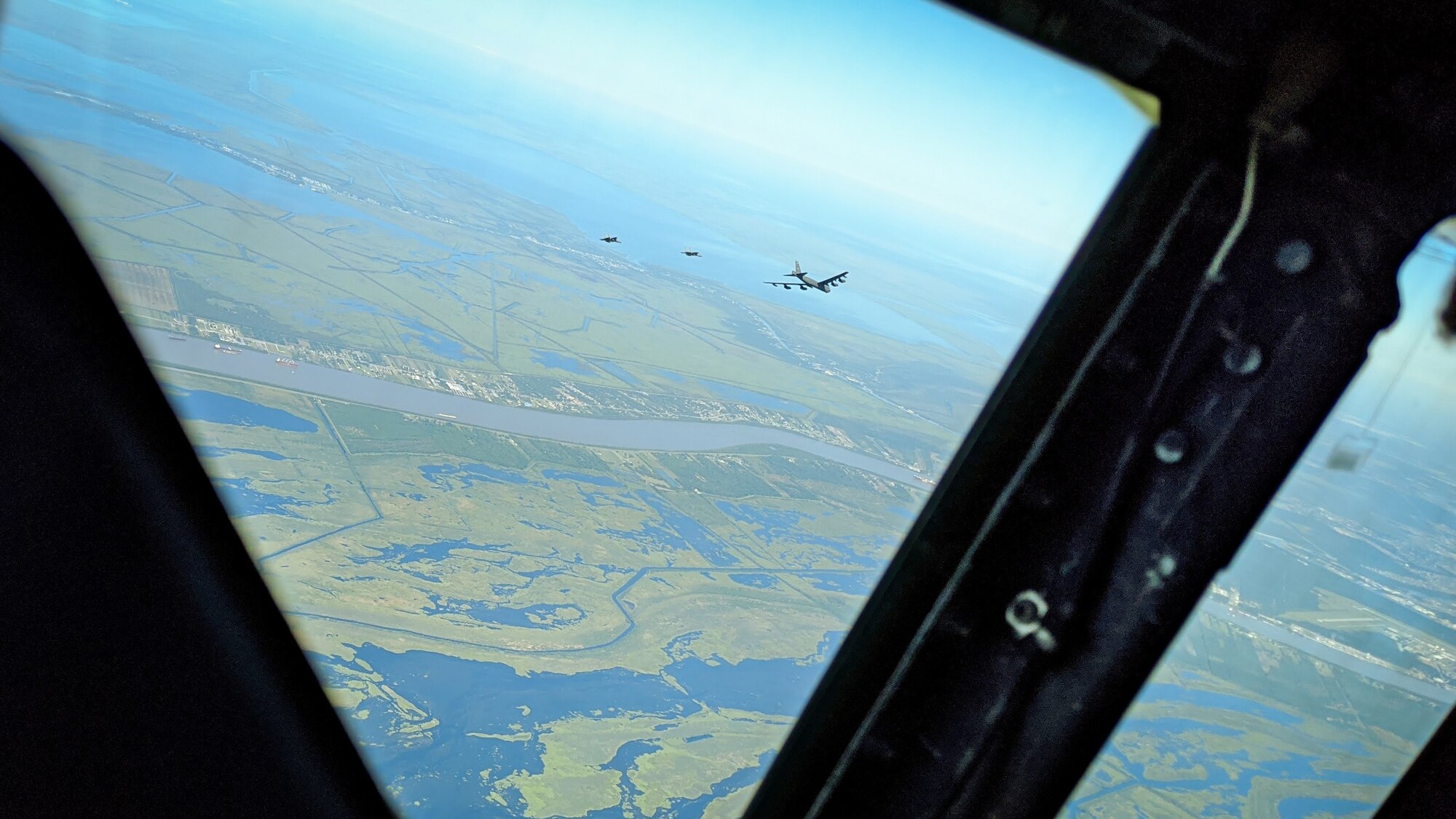 A B-52H Stratofortress and two F-15 Strike Eagles fly over South Louisiana, May 1, 2020.