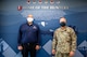 Col. Brian Snyder, 432nd Mission Support Group commander, and Matthew Beatty, Nellis/Creech Air Force Base Exchange general manager, pose for a photo inside a blue mural.