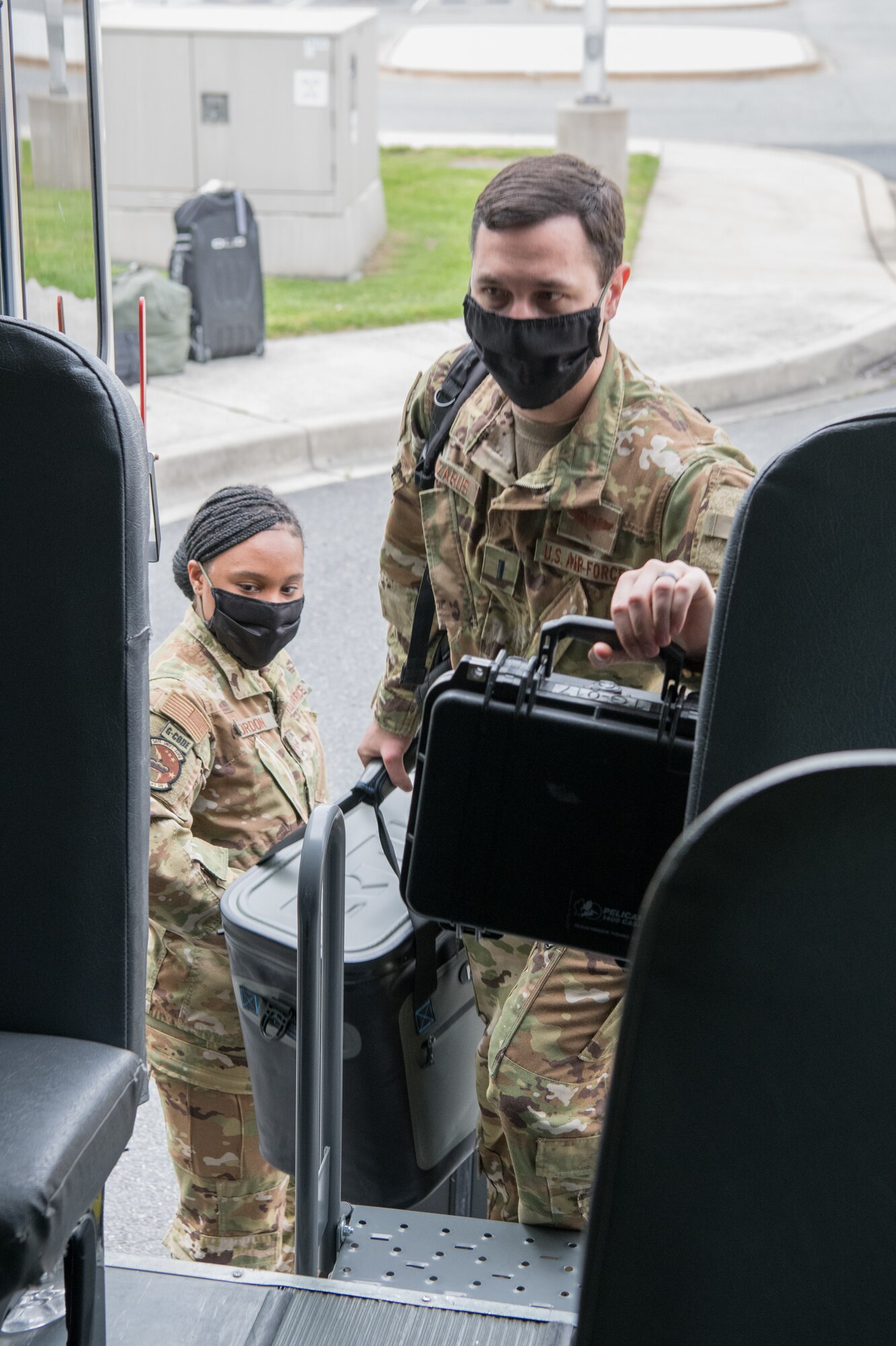 A C-17 Globemaster III aircrew with the 3rd Airlift Squadron enters a transport bus using the rear emergency door May 1, 2020, at Dover Air Force Base, Delaware. Entering from the rear of the bus and installing a plexiglass partition between the driver’s seat and the passenger section help mitigate the potential spread of COVID-19 while transporting aircrews to and from the flight line. (U.S. Air Force photo by Mauricio Campino)