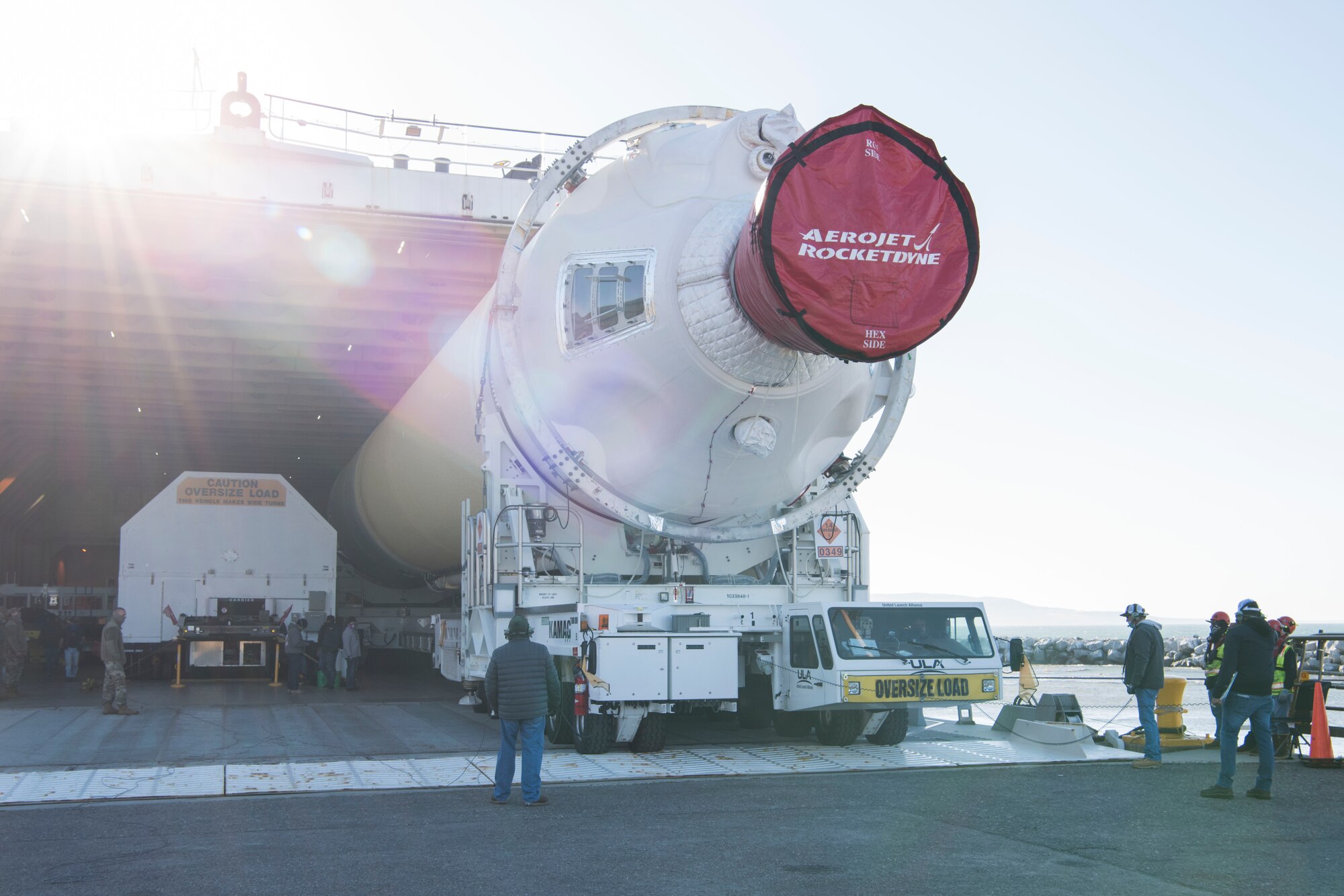 Mission partners and base members extract a Delta IV Heavy booster from a United Launch Alliance barge, known as the RocketShip, May 4, 2020, at Vandenberg Air Force Base, Calif. The barge docked at Vandenberg AFB to offload the final Delta IV Heavy booster for an upcoming launch scheduled to occur later this year. The barge operation is a vital first step to executing the mission of assured access to space. (U.S. Air Force photo by Senior Airman Aubree Owens)