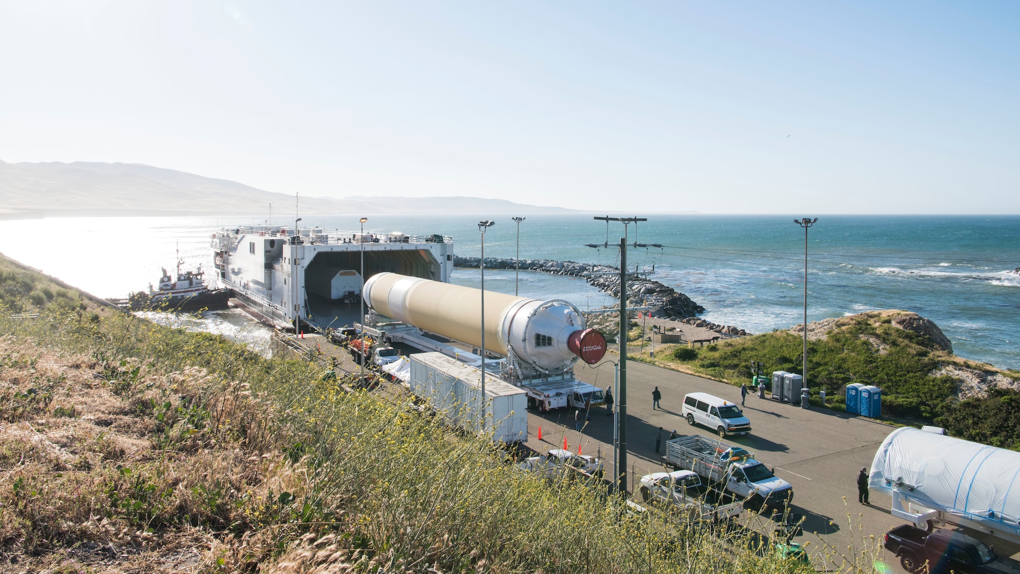 Mission partners and base members extract a Delta IV Heavy booster from a United Launch Alliance barge, known as the RocketShip, May 4, 2020, at Vandenberg Air Force Base, Calif. The barge docked at Vandenberg AFB to offload the final Delta IV Heavy booster for an upcoming launch scheduled to occur later this year. The barge operation is a vital first step to executing the mission of assured access to space. (U.S. Air Force photo by Senior Airman Aubree Owens)