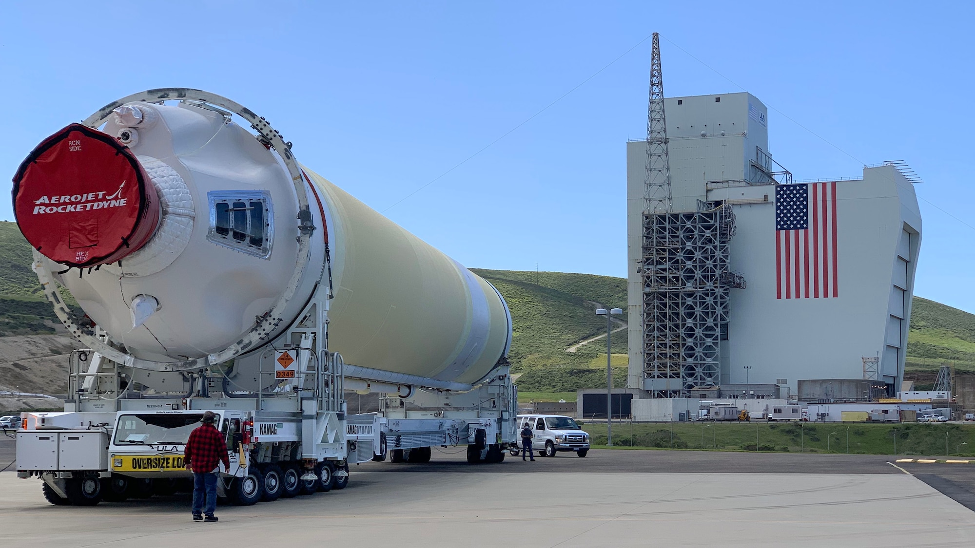 A Delta IV Heavy booster from a United Launch Alliance barge, known as the RocketShip, proceeds to the Horizontal Integration Facility May 4, 2020, at Vandenberg Air Force Base, Calif. A HIF is a building within which the stages of a multistage rocket are brought together before the assembled stack is rolled out to the launch pad or space launch complex and raised into a vertical position for final integration and launch. (Courtesy photo)