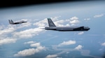 A B-52H Stratofortress and an F-15 Strike Eagle fly over South Louisiana, May 1, 2020.