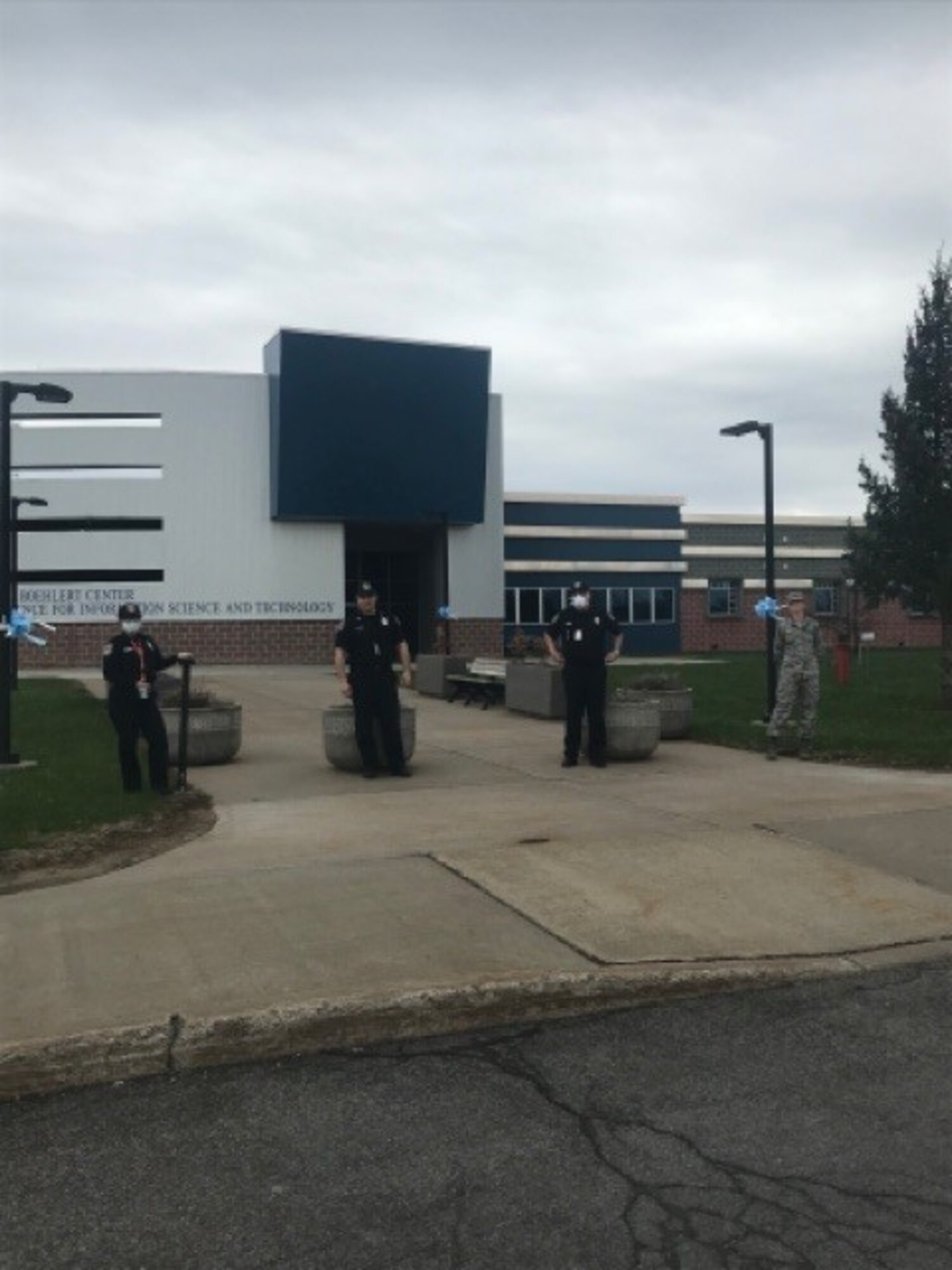 Mission essential personnel at AFRL’s Information Directorate alongside donated bows. (Courtesy photo)