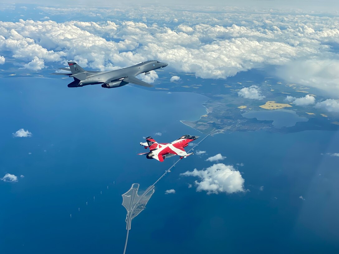 A B-1B Lancer flies with a Danish F-16 during a training mission for Bomber Task Force Europe, May 5, 2020. Aircrews from the 28th Bomb Wing at Ellsworth Air Force Base, South Dakota, took off on their long-range, long-duration Bomber Task Force mission to conduct interoperability training with Danish fighter aircraft and Estonian joint terminal attack controllers ground teams. Training with our NATO allies and theater partner nations contribute to enhanced resiliency and interoperability and enables us to build enduring relationships necessary to confront the broad range of global challenges. (Courtesy photo by Danish Air Force)