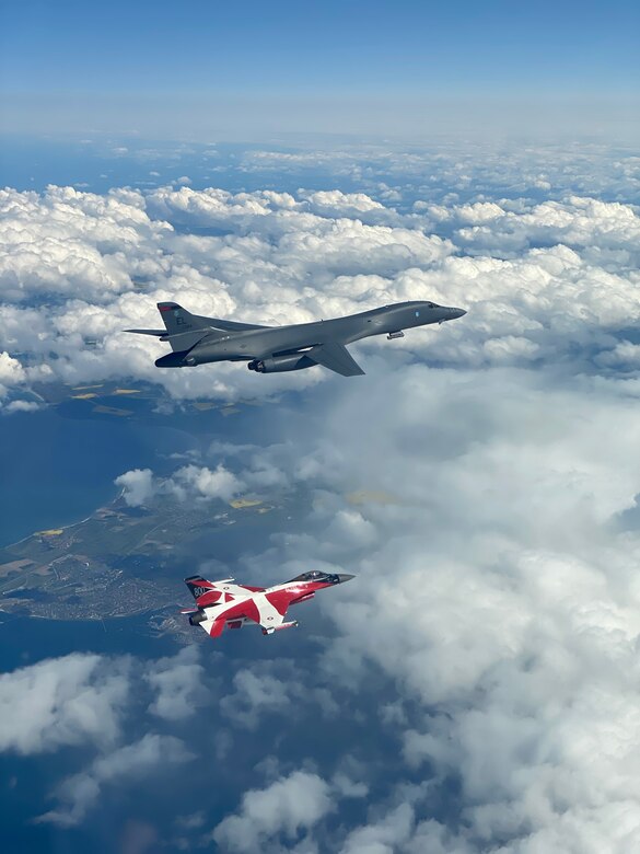 A B-1B Lancer flies with a Danish F-16 during a training mission for Bomber Task Force Europe, May 5, 2020. Aircrews from the 28th Bomb Wing at Ellsworth Air Force Base, South Dakota, took off on their long-range, long-duration Bomber Task Force mission to conduct interoperability training with Danish fighter aircraft and Estonian joint terminal attack controllers ground teams. Training with our NATO allies and theater partner nations contribute to enhanced resiliency and interoperability and enables us to build enduring relationships necessary to confront the broad range of global challenges. (Courtesy photo by Danish Air Force)