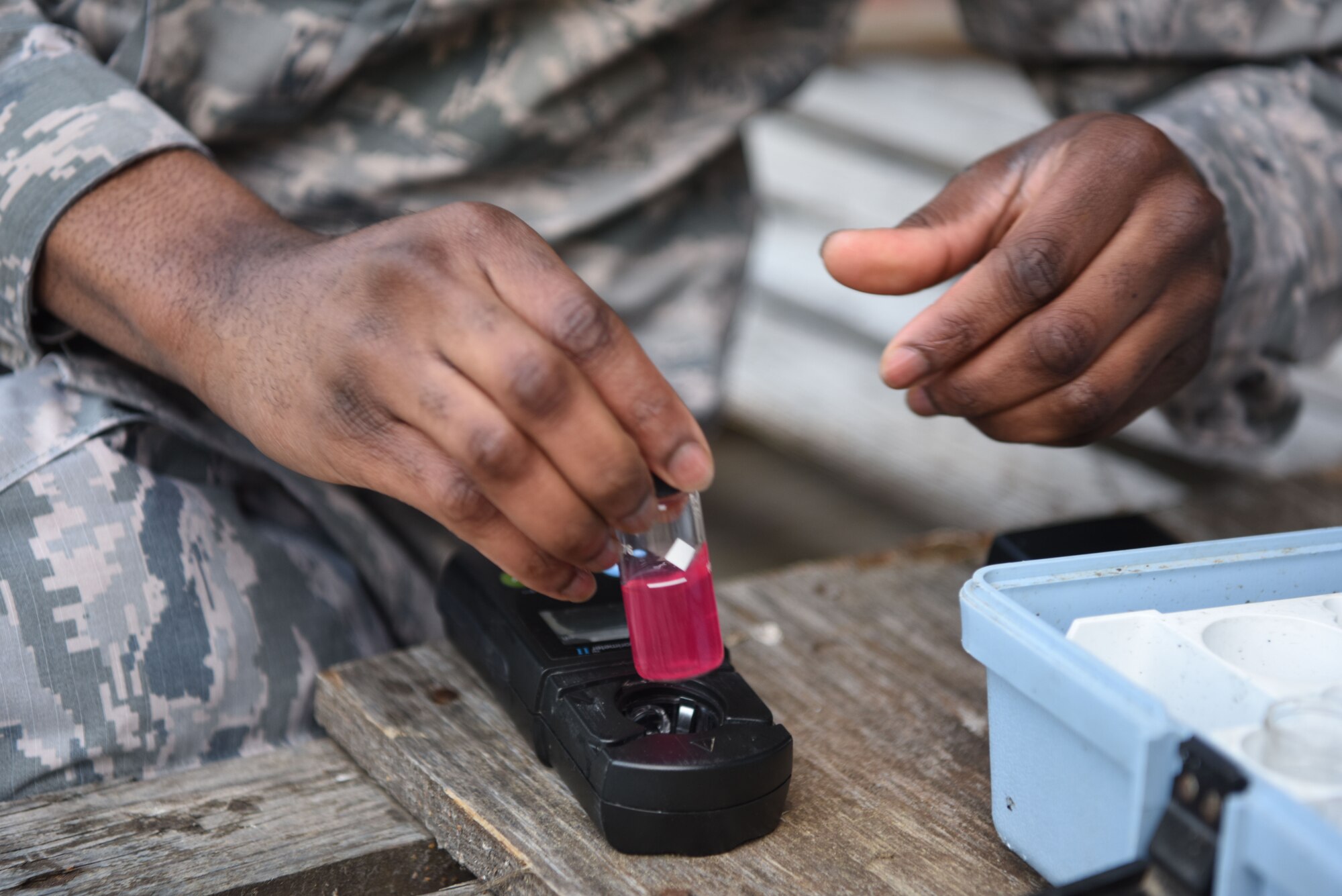 U.S. Air Force Senior Airman Brandon Williams, 786th Civil Engineer Squadron water and fuel systems maintenance journeyman, tests the chlorine level of a water vial.