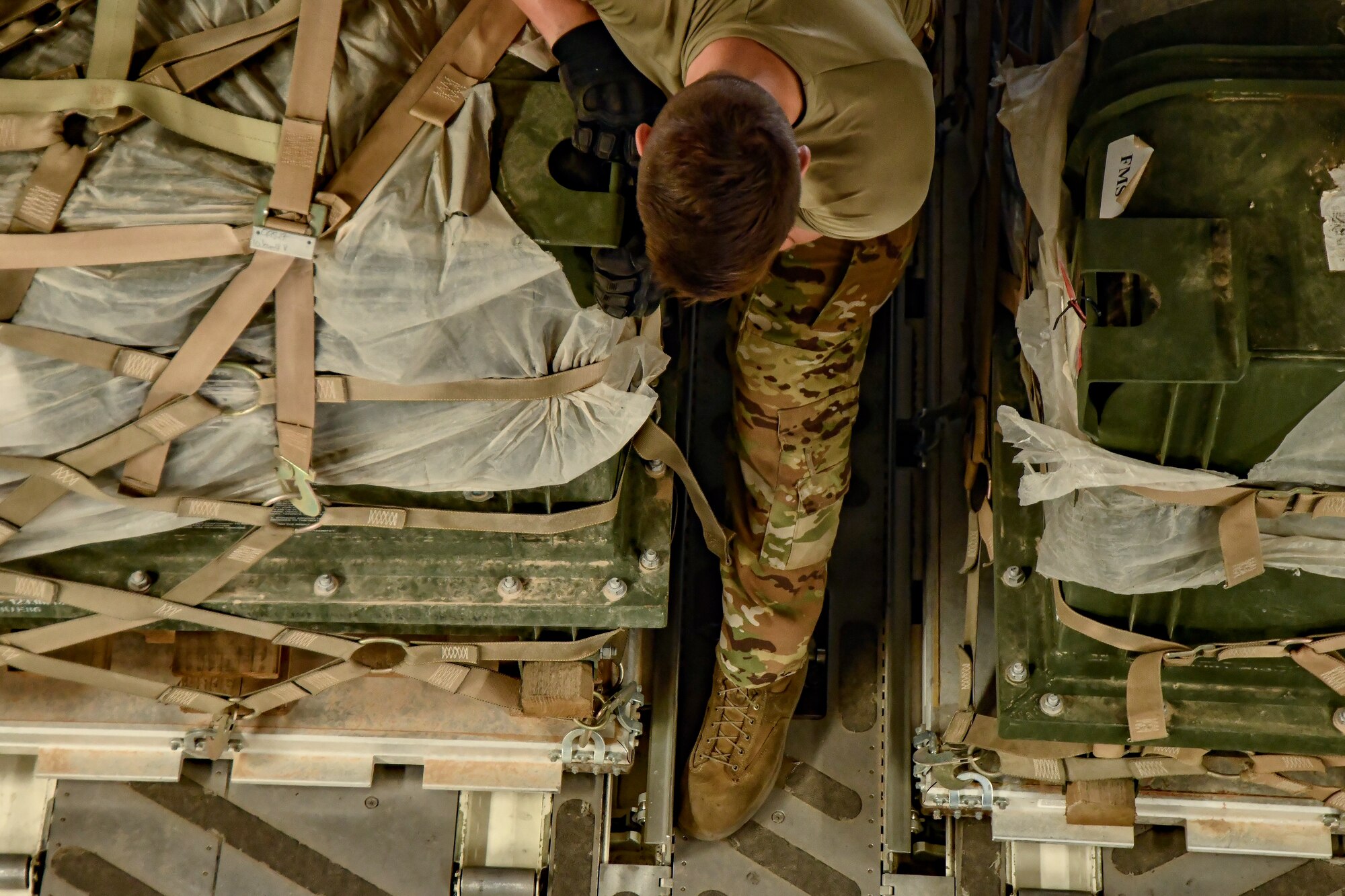 Airman secures cargo on a transport aircraft.