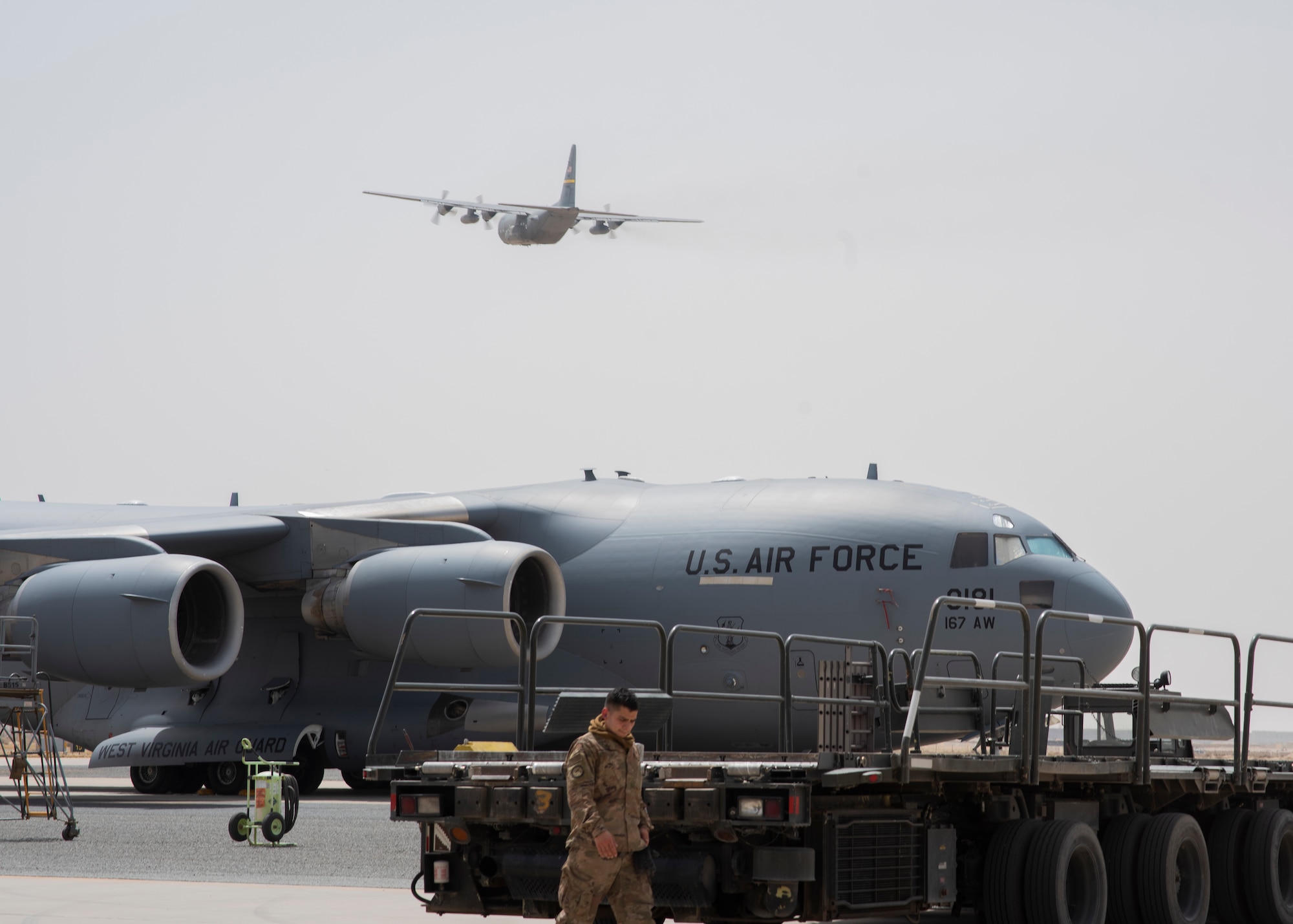 Aircraft flies over the flightline.