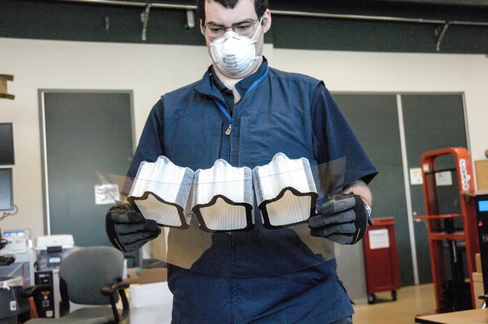 Scott Ziv, an engineer in the Additive Manufacturing Project Office at Naval Surface Warfare Center Carderock Division, inspects a set of face covering frames after they were 3D printed on April 14, 2020, in Carderock’s Manufacturing, Knowledge and Education Lab in West Bethesda, Md.