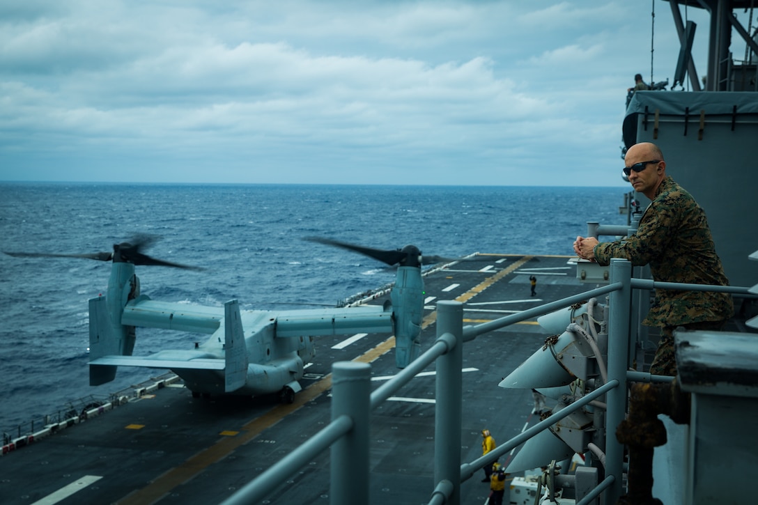 A U.S. Marine watches MV-22B tiltrotor aircraft prepare to take off from the flight deck of amphibious assault ship USS America, April 27.