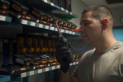 Staff Sgt. Miguel Meraz, 437th Aircraft Maintenance Squadron Viper Flight Composite Tool Kit Section shift supervisor, uses a radio to coordinate tool turn-in May 1, 2020, at Joint Base Charleston, S.C. The 437th AMXS CTK Section is responsible for the accountability of thousands of pieces of equipment including more than 2,000 tool kits. The CTK team implemented a process where maintainers disinfect their tools prior to turn in. After communicating over radio, tools are sanitized in a designated room used for tool transfer with personnel keeping a six foot distance to help prevent health risks associated with COVID-19.