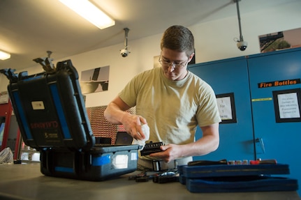 Senior Airman Sean Graves, 437th Aircraft Maintenance Squadron Viper Flight Composite Tool Kit Section custodian, sanitizes tools and equipment May 5, 2020, at Joint Base Charleston, S.C. The 437th AMXS CTK Section is responsible for the accountability of thousands of pieces of equipment including more than 2,000 tool kits. The CTK team implemented a process where maintainers disinfect their tools prior to turn in. After communicating over radio, tools are sanitized in a designated room used for tool transfer with personnel keeping a six foot distance to help prevent health risks associated with COVID-19.