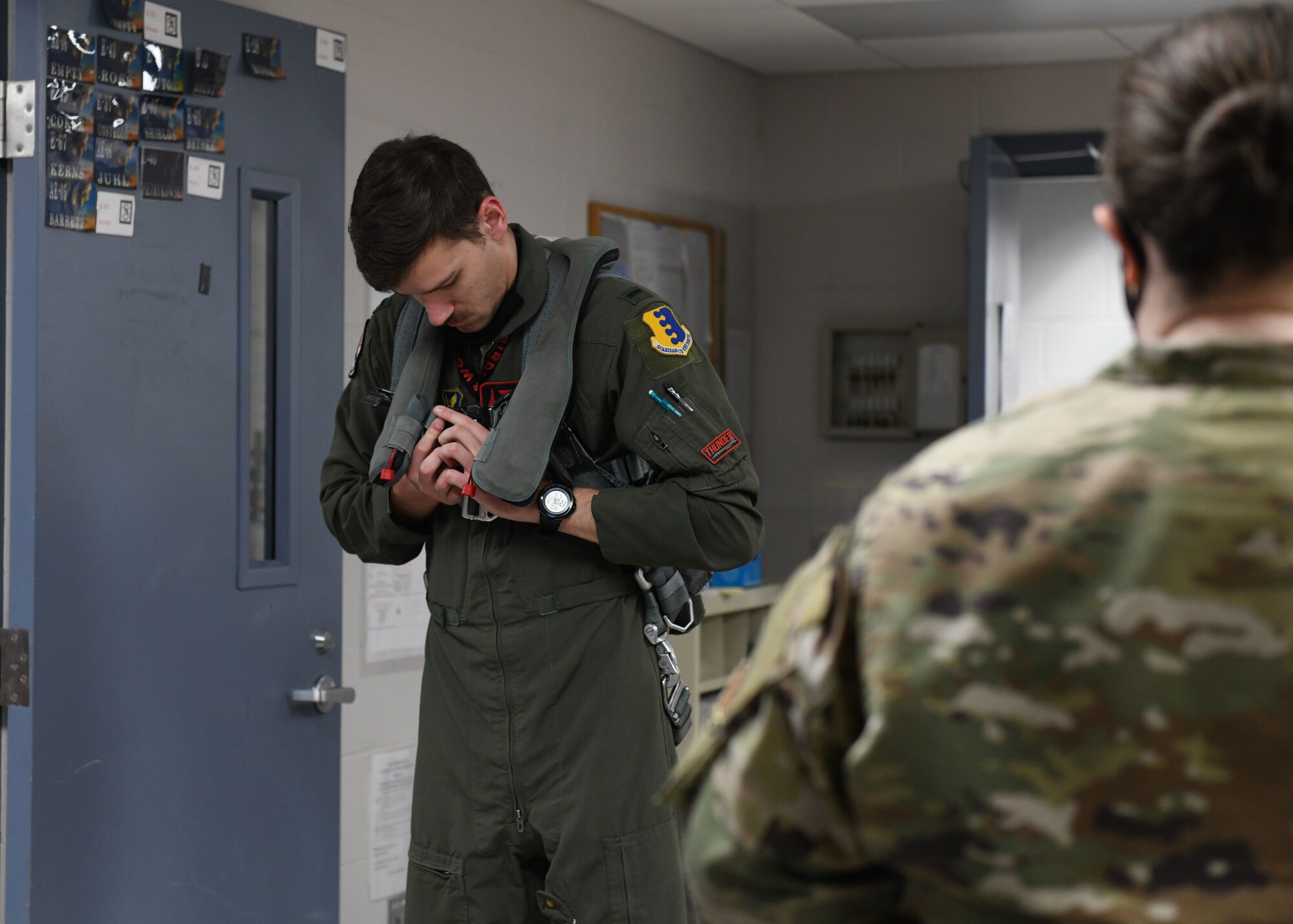 An aviator from the 34th Bomb Squadron prepares his flight equipment prior to a more than 25-hour non-stop mission from Ellsworth Air Force Base, S.D., May 4, 2020. Bomber Task Force deployments enhance the readiness and training necessary to respond to any contingency or challenge across the globe.  (U.S. Air Force photo by Airman 1st Class Christina Bennett)